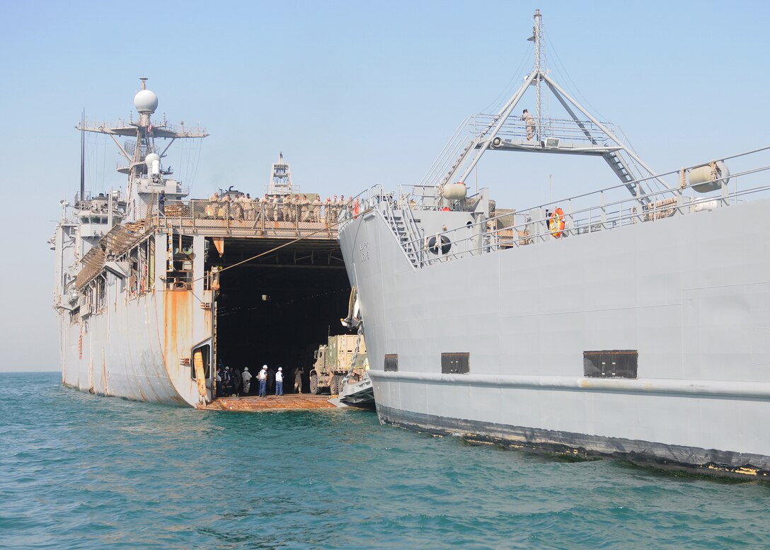 Amphibious dock landing ship USS Carter Hall (LSD 50) performs a stern gate transfer with U.S. Army logistics support vessel USAV SP/4 James A. Loux (LSV-6).  During a stern gate transfer, two ships at sea connect to transport supplies, equipment and personnel.Carter Hall is part of Kearsarge Amphibious Ready Group, supporting maritime security operations and theater security cooperation efforts in the U.S. 5th Fleet area of responsibility. (U.S. Navy photo by Mass Communication Specialist 3rd Class Kristin L. Grover/Released)