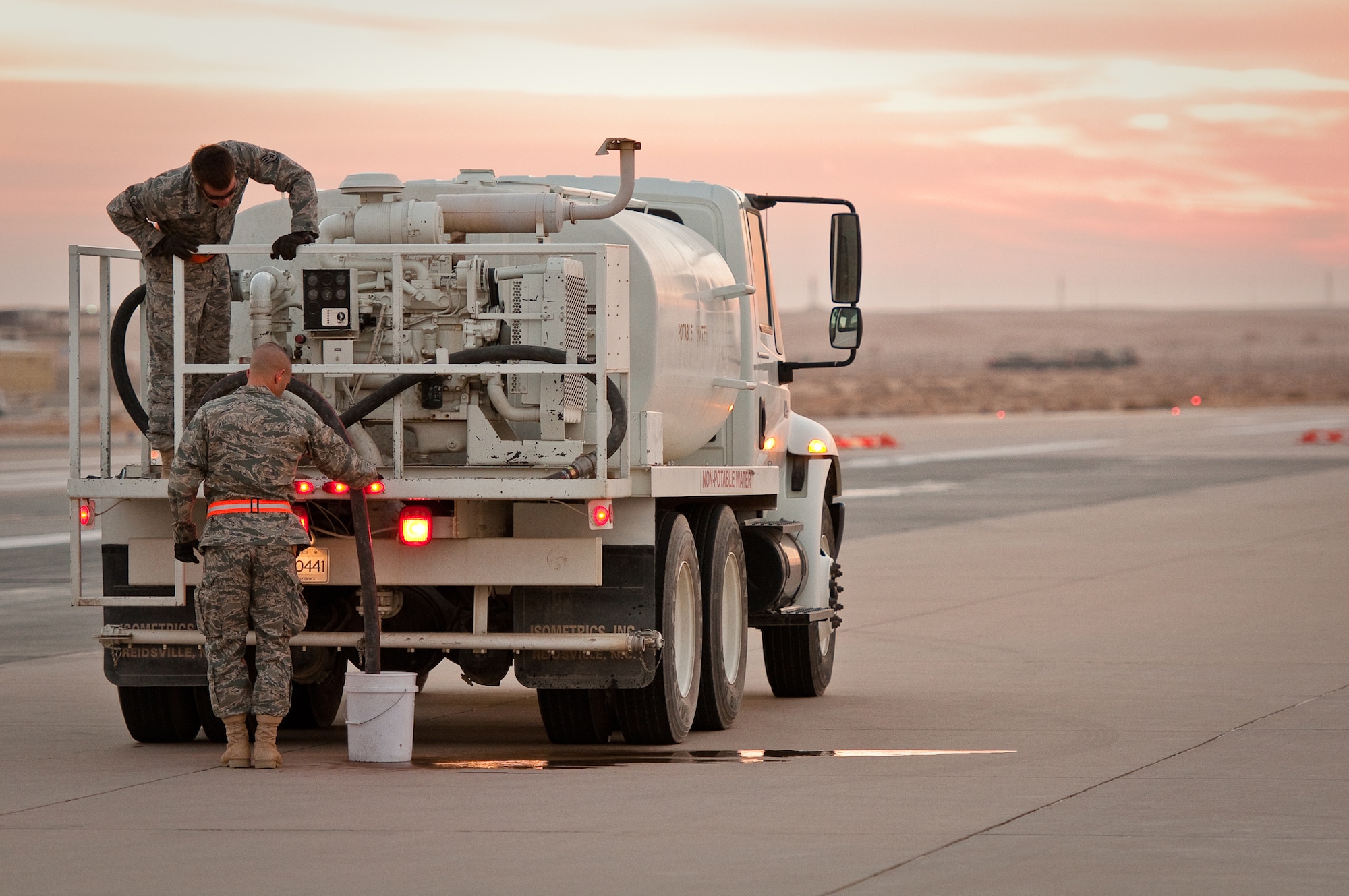 SOUTHWEST ASIA - Staff Sgt. Brandon Terhune (left) and Capt. Jason Adams of the 386th Expeditionary Civil Engineer Squadron prepare to mix mortar Dec. 10, 2010, for runway repairs at the 386th Air Expeditionary Wing. The repairs will prevent decaying concrete from causing damage to aircraft during takeoffs and landings at an undisclosed air base here. (U.S. Air Force photo by Maj. Dale Greer)
