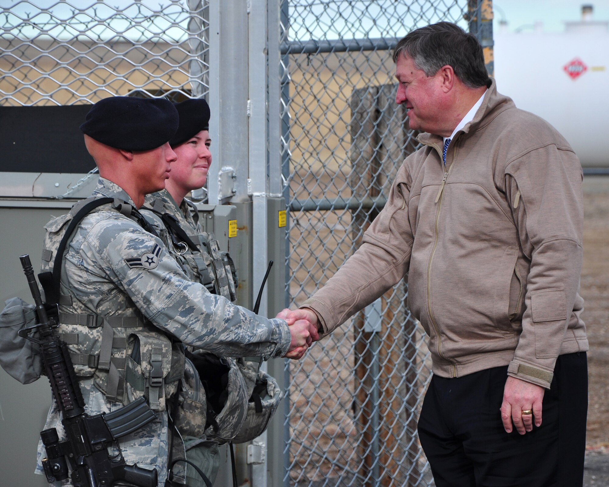 Secretary of the Air Force Michael Donley greets Airman 1st Class Isaiah Preece and Airman 1st Class Brittany Fenn, both with the 90th Missile Security Forces Squadron, at a missile alert facility Dec. 23, 2010, during a visit to F. E. Warren Air Force Base, Wyo.  While there, Secretary Donley walked through workplaces at 20th Air Force headquarters, 90th Missile Wing maintenance facilities and a missile alert facility to offer his appreciation to Warren Airmen in person for a mission that he has said before demands “the highest standards of performance and accountability.” During his trip, he also had the opportunity to talk with and thank Airmen serving on duty. (U.S. Air Force photo/Staff Sgt. Chad Thompson)