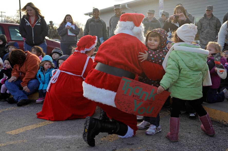 Santa and Mrs. Claus greet children enrolled in the Youth & Family Services Child Care program in Rapid City, S.D., Dec. 16, as part of the 28th Operations Group Angel Tree Program.  The purpose of the visit was to spread goodwill and distribute gifts donated by various organizations from Ellsworth Air Force Base.  (U.S. Air Force photo/Staff Sgt. Marc I. Lane)