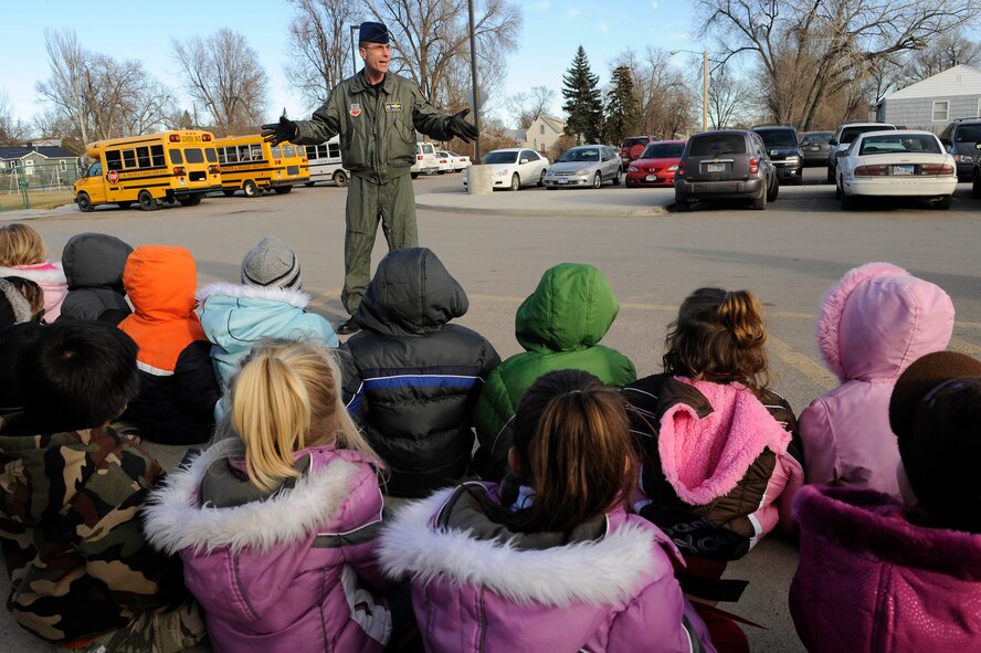 Col. William Eldridge, 28th Operations Group commander, talks with a crowd of children enrolled in the Youth & Family Services Child Care program in Rapid City, S.D., Dec. 16.  Airmen from the 28th OG coordinated the donation and distribution of 170 gifts to the YFS Child Care program. (U.S. Air Force photo/Staff Sgt. Marc I. Lane)