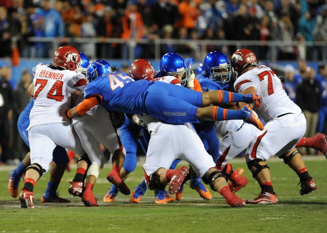 LAS VEGAS -- Darren Mackey of the Boise State Broncos goes for a ride as he holds on to the quarterback for a tackle in the first quarter of the MAACO Las Vegas Bowl at Sam Boyd Stadium Dec 22. More than 200 Airmen from Nellis and Creech Air Force Bases attended the game after saluting in formation for the opening ceremonies. (U.S. Air Force photo by Airman 1st Class Daniel Hughes/Released)
