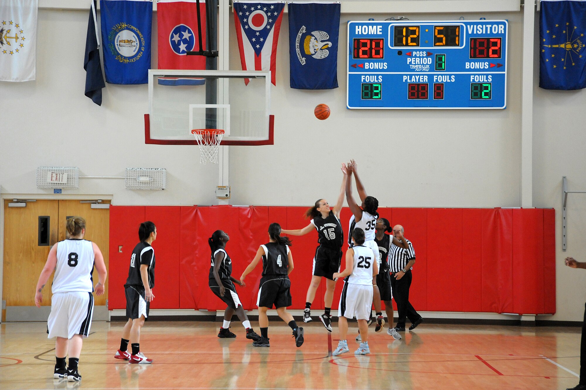 LAAFB Storm player, Candy Cleverly, attempts to block a shot by a Vandenberg’s Lady Hawks player during the Dec. 18, 2010, game.  The Storm reigned the court in a 53-22 win.  (Photo by Joe Juarez)