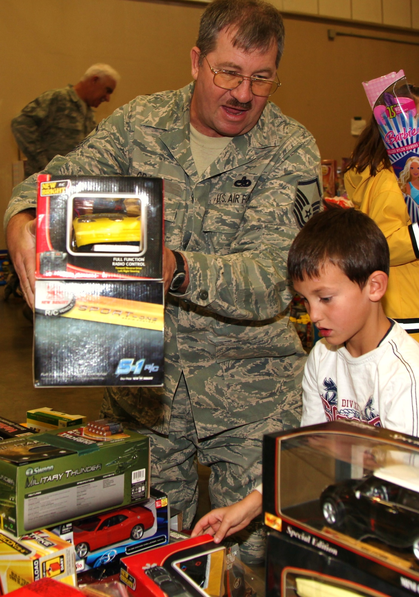 A member of the 940th Wing helps an eager participant choose a toy during the Military Children’s Christmas Party at the Roseville, Calif. National Guard Armory, Dec. 18. The party was organized by Never Forget Our Fallen, an organization started by Deborah Getz in honor of her son who lost his life in 2007 while serving with the Army in Afghanistan. (U.S. Air Force photo/Tech. Sgt. Kenneth McCann) 
