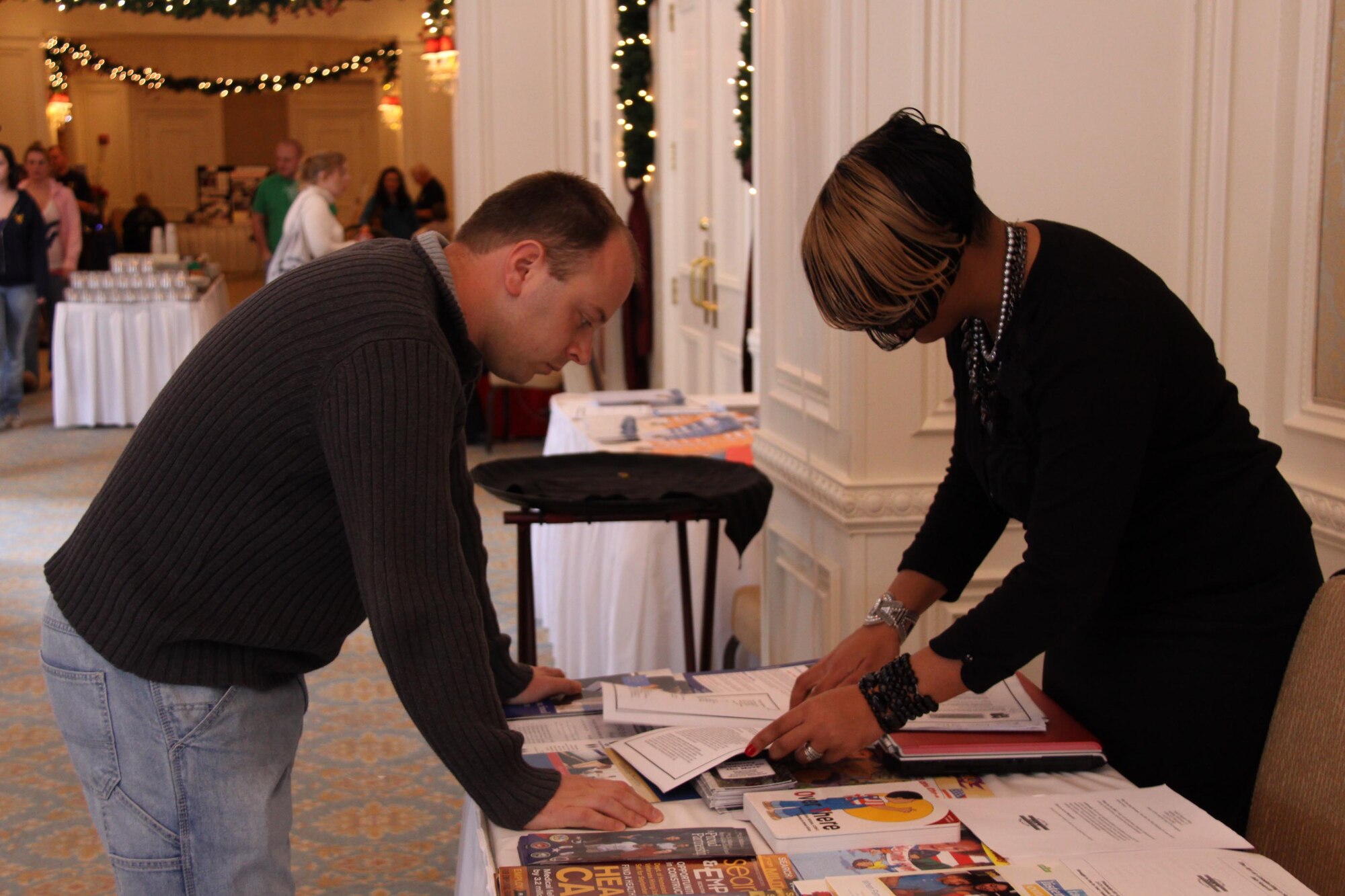 Captain Craig Watkins, navigator with the 758th Airlift Squadron, speaks with Tech. Sgt. Raelin McCune, family readiness technician with the 911th Family Readiness Office at the Yellow Ribbon event held in Farmington, Pa., Dec. 18 and 19, 2010. Family Readiness provides members with information on a wide variety of resources available ranging from reintegration support for Airman returning from deployment to scholarship information for those seeking higher education.