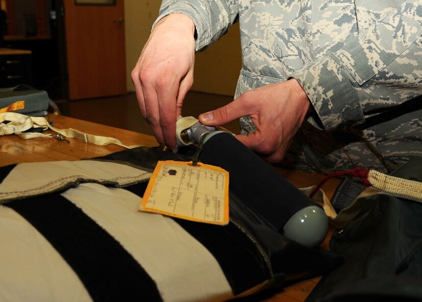 Dyess Air Force Base, Texas - Airman 1st Class Sean Meares, 7th Operations Support Squadron aircrew flight equipment technician, assembles a survival kit to be put on the B-1 Bomber. The operations support squadron is responsible for B-1 Bomber combat effectiveness. The squadron directs wing flight operations, conventional mission planning, combat tactics, airfield management, aircrew training, exercise scheduling, aircraft scheduling, weapons and tactics standardization, intelligence integration, war plans, deployment planning, weather support, small computer support, simulator training, air traffic control and wing life support functions. (U.S. Air Force photo/Airman 1st Class Courtney Moses)