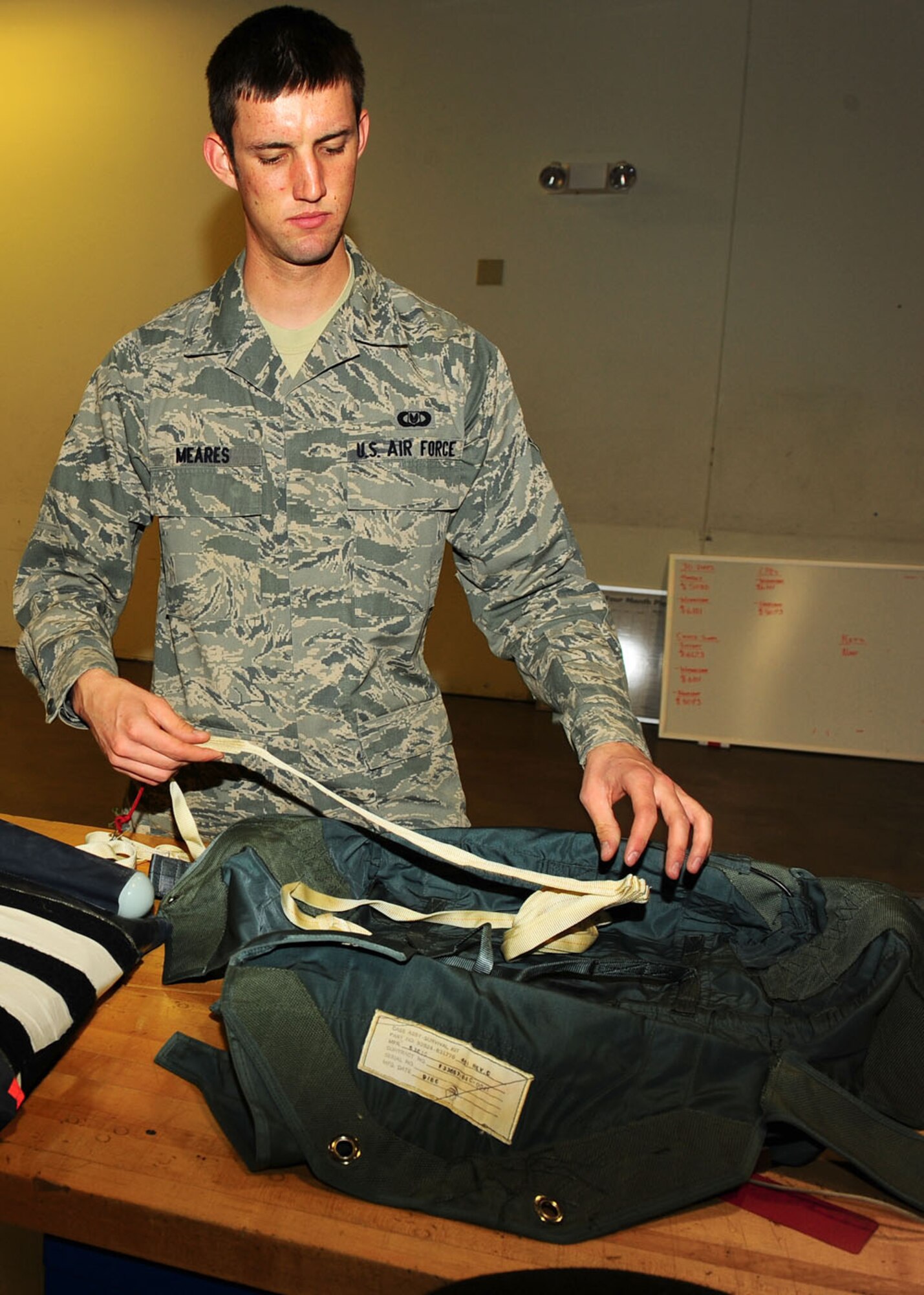 Dyess Air Force Base, Texas - Airman 1st Class Sean Meares, 7th Operations Support Squadron aircrew flight equipment technician, assembles a survival kit to be put on the B-1 Bomber. The operations support squadron is responsible for B-1 Bomber combat effectiveness. The squadron directs wing flight operations, conventional mission planning, combat tactics, airfield management, aircrew training, exercise scheduling, aircraft scheduling, weapons and tactics standardization, intelligence integration, war plans, deployment planning, weather support, small computer support, simulator training, air traffic control and wing life support functions. (U.S. Air Force photo/Airman 1st Class Courtney Moses)