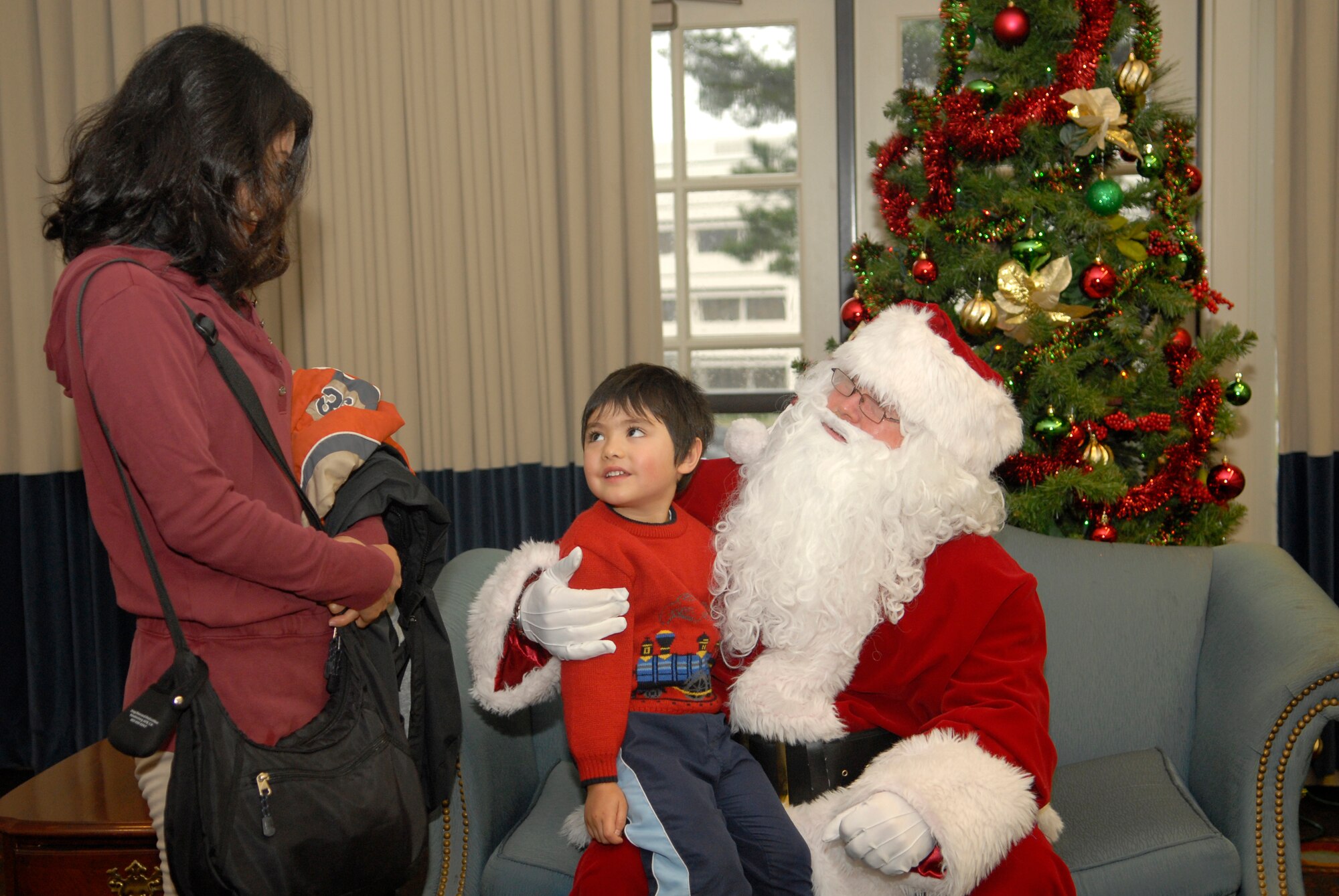VANDENBERG AIR FORCE BASE, Calif. -- Taiga Ross gives his Christmas wish to Santa at the Pacific Coast Club during the Breakfast With Santa event here Saturday, Dec. 18, 2010.  Team V families celebrated the holidays with breakfast, crafts and games.  (U.S. Air Force photo/Senior Airman Andrew Satran) 

  