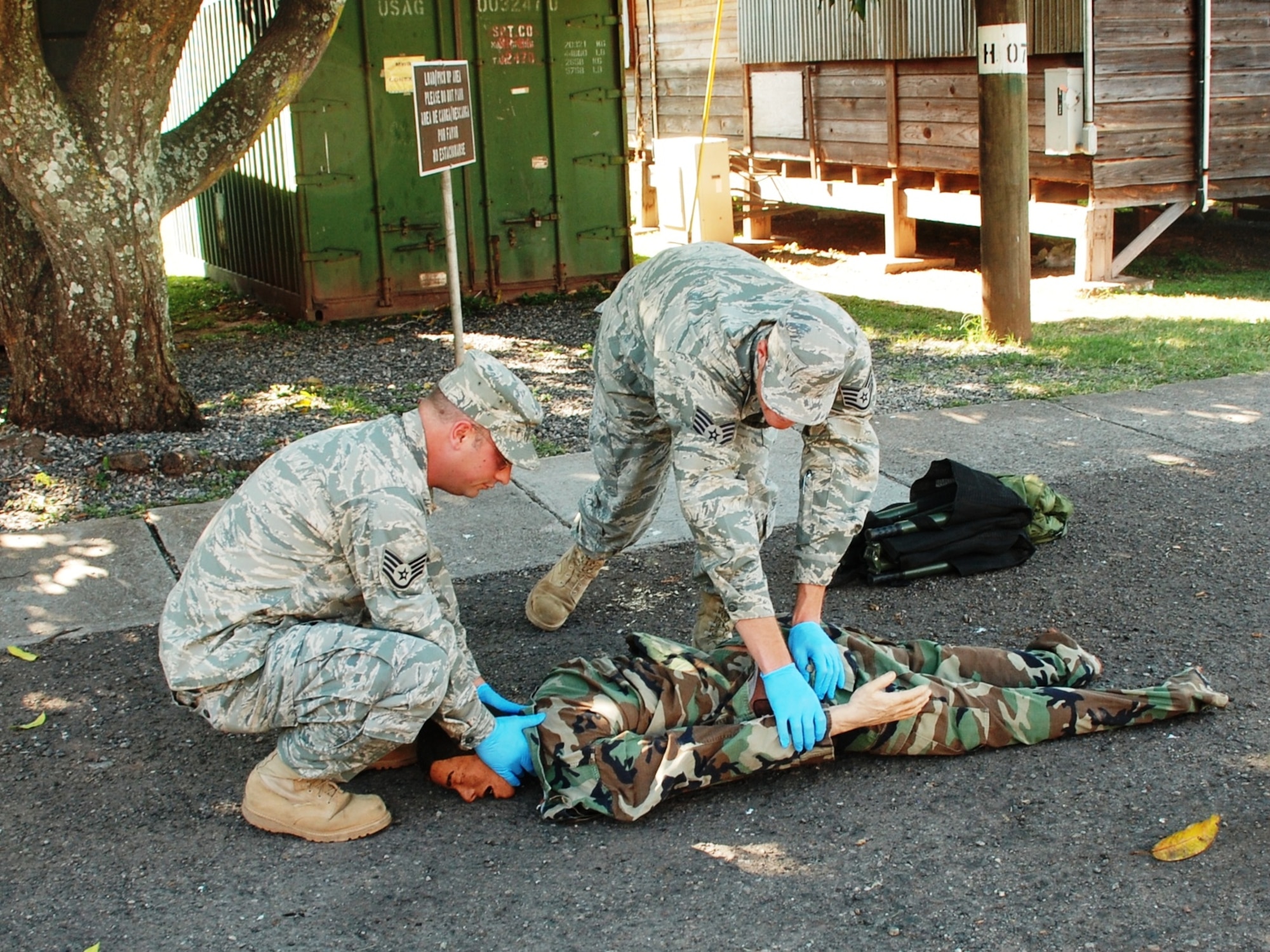 SOTO CANO AIR BASE, Honduras - Two Airmen from Joint Task Force-Bravo perform Combat Lifesaver techinques on a practice dummy during training here Dec. 14.  CLS training address proper techniques and procedures to take care of injured Soldiers, which will allow first responders to ensure maximum survivability on the battlefield.  (U.S. Air Force photo/Army PFC Kelvin Rivera)