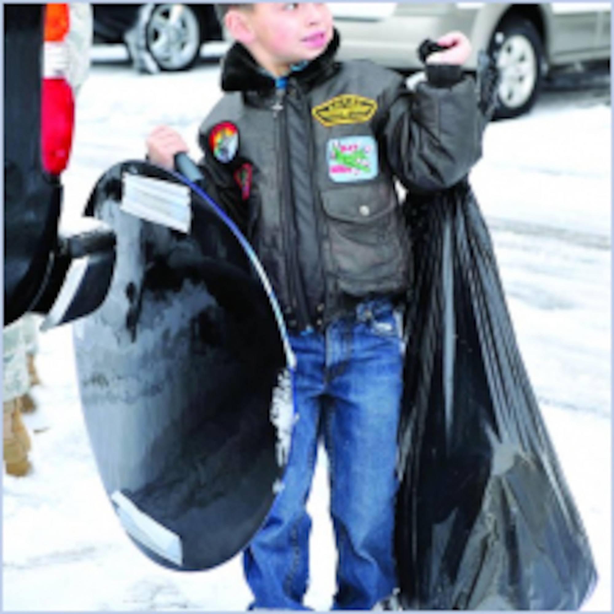 Gavin Munn, son of Senior Master Sgt. Trey Munn, 388th Accessories Flight Chief, helps load a bag of toys for delivery. (U.S. Air Force photo by Kim Cook)