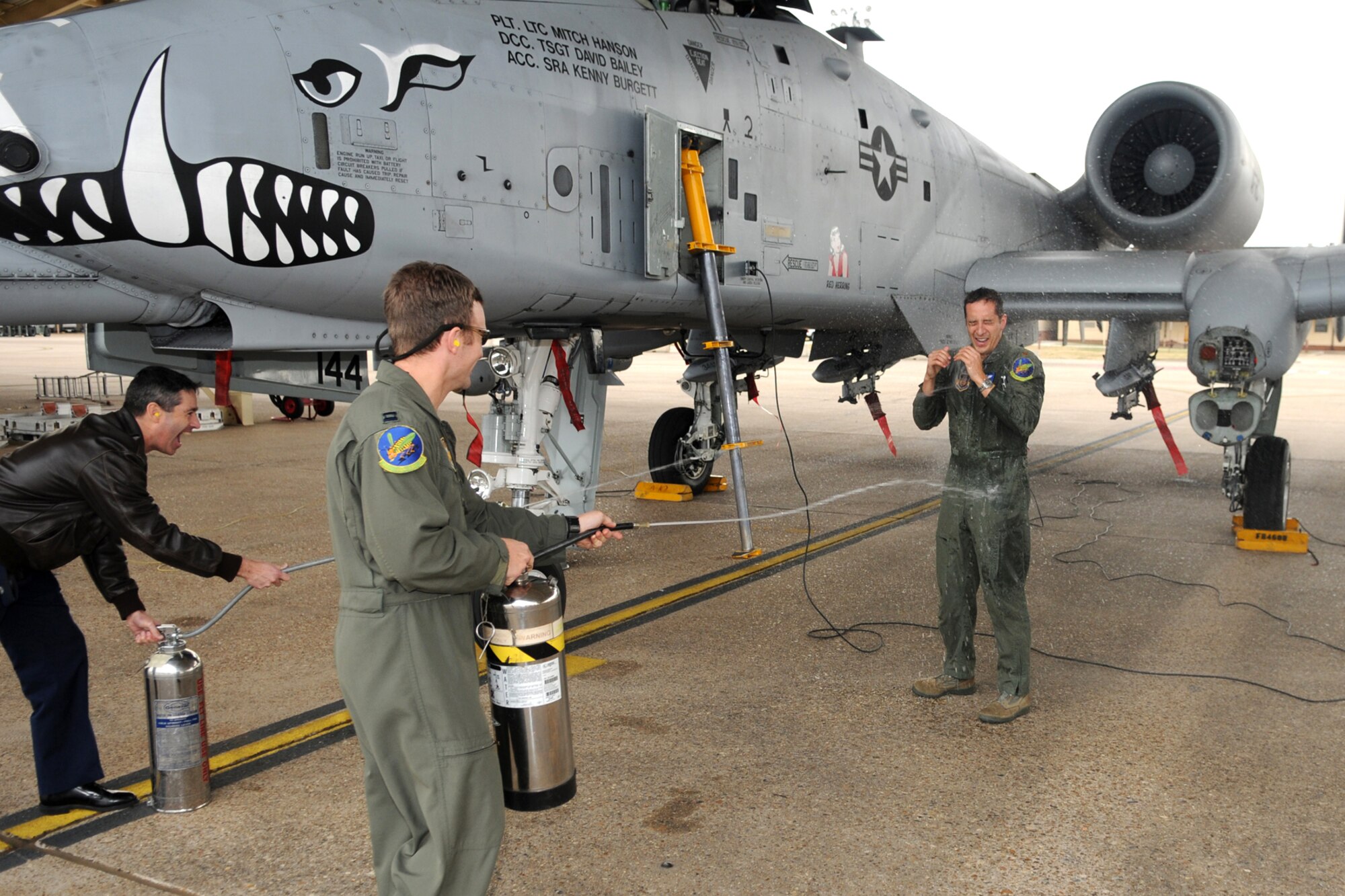 Lt. Col. Pat McKeever, former 47th Fighter Squadron pilot, and Capt. Jason Cobb, 47th FS pilot, hose down Maj. Aristotle Rabanal after returning from his final flight with the squadron on Dec. 21, 2010, 917th Wing, Barksdale Air Force Base, La. (U.S. Air Force/MSgt Greg Steele)