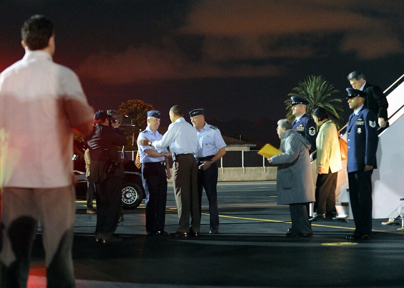 President Barack Obama greets Col. Sam Barrett, 15th Wing commander, upon landing at Joint Base Pearl Harbor-Hickam, Hawaii Dec. 22. President Obama arrived aboard Air Force One around 11:45 p.m. The aircraft parked at the 15th Wing, JBPH-H, where the President departed in a motorcade. The President and his family are expected to stay in Hawaii through the new year. (U.S. Air Force photo/Staff Sgt. Nathan Allen)