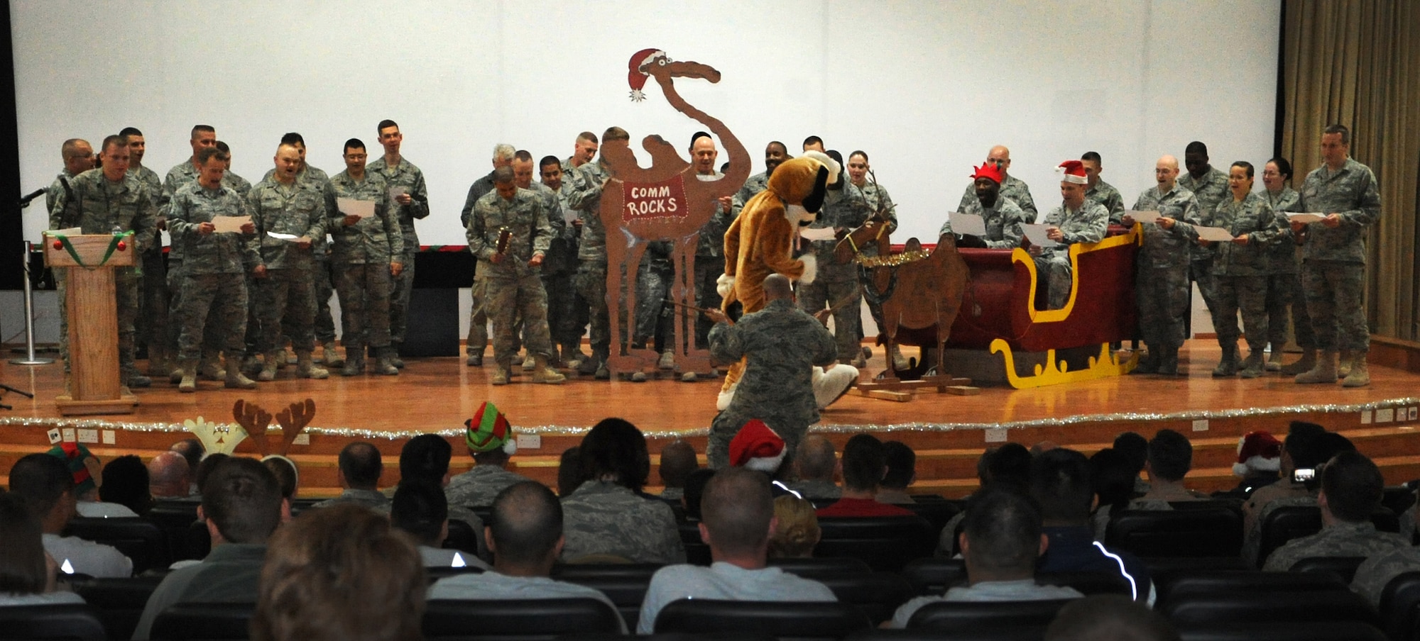 SOUTHWEST ASIA -- Airmen with the 386th Air Expeditionary Wing participate in a Christmas caroling contest at the base theater Dec. 20. The caroling competition was one of the many scheduled events to boost the holiday spirit of Airmen deployed during the holidays. (Air Force photo by Senior Airman Cynthia Spalding)