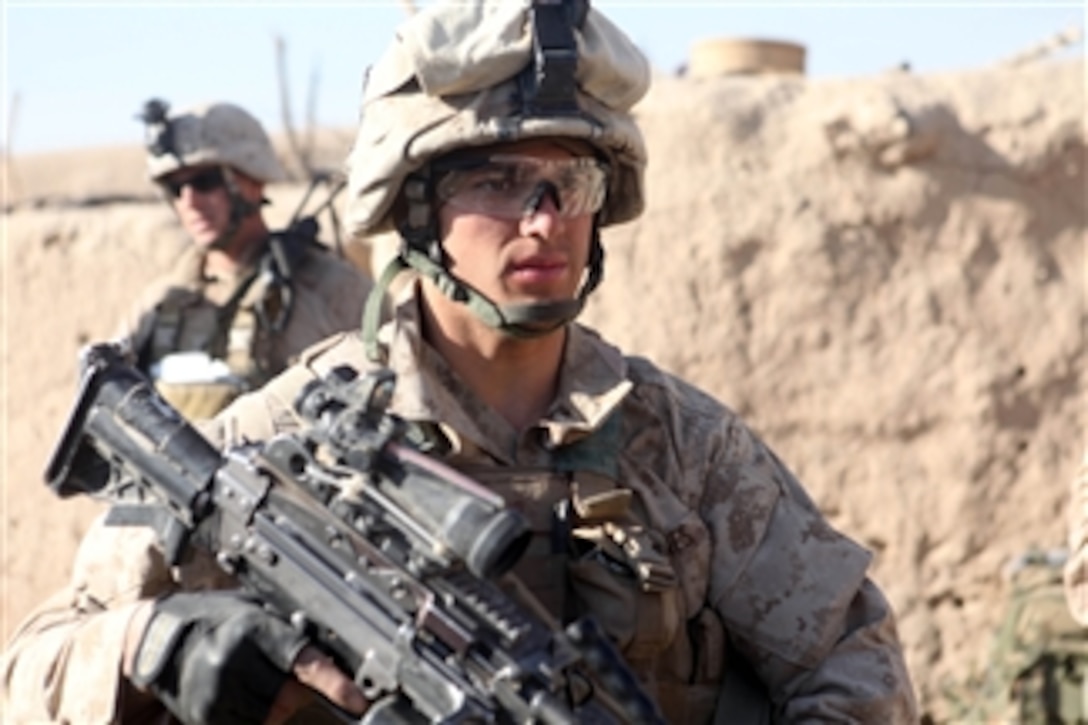 U.S. Marine Corps Lance Cpl. Miguel Trevino, with India Company, 3rd Battalion, 5th Marine Regiment, prepares to search and clear a compound during Operation Outlaw Wrath in Sangin Valley, Afghanistan, on Dec. 1, 2010.  Outlaw Wrath is a battalion operation to clear routes of improvised explosive devices and enemy combatants.  The battalion was one of the combat elements of Regimental Combat Team 2, whose mission was to conduct counterinsurgency operations in partnership with the International Security Assistance Force.  