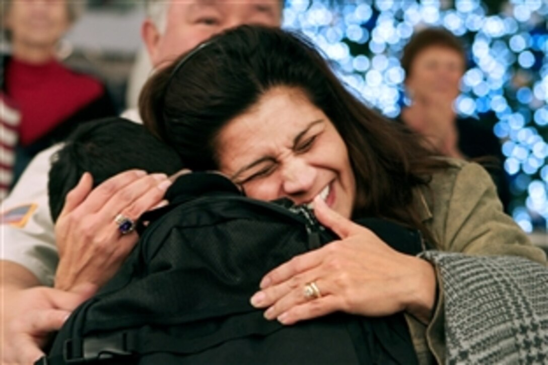 A happy mother embraces her daughter at Baltimore-Washington International Thurgood Marshall Airport, Md., Dec. 22, 2010. The daughter arrived in the United States in time for the holidays along with 260 other military members after months of service abroad.