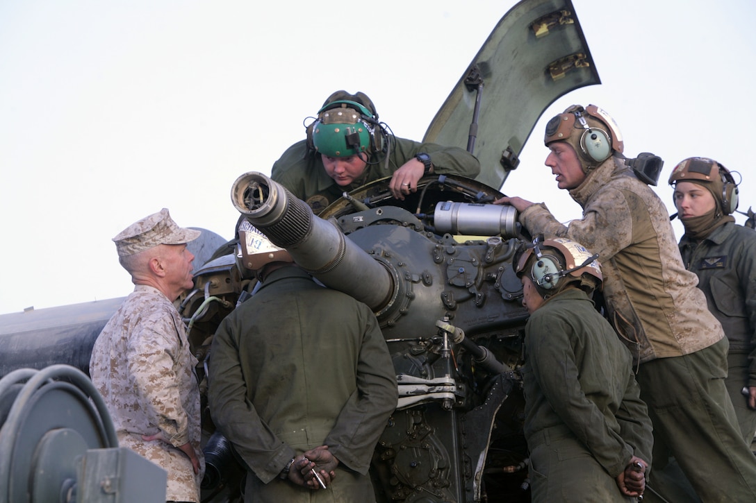 The 35th commandant of the Marine Corps, Gen. James F. Amos, speaks to a group of aircraft mechanics from Marine Medium Tiltrotor Squadron 365, 3rd Marine Aircraft Wing (Forward), as they work on a MV-22B Osprey rotor, Dec. 23.  Amos, along with Sgt. Maj. Carlton W. Kent, sergeant major of the Marine Corps, visited several bases throughout Afghanistan to wish the troops merry Christmas.