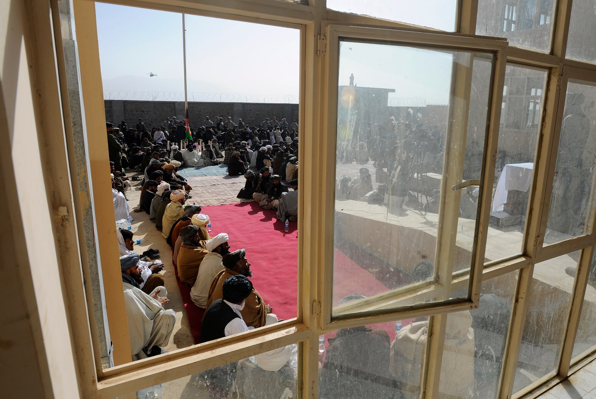 Shajoy District elders listen as Zabul Provincial Gov. Ashraf Naseri speaks during the opening of the Shajoy District Center, Dec. 23. Provincial leaders were on hand to open the district center and speak to the more than 90 local villagers in attendance. (U.S. Air Force photo/Staff Sgt. Brian Ferguson) (Released).