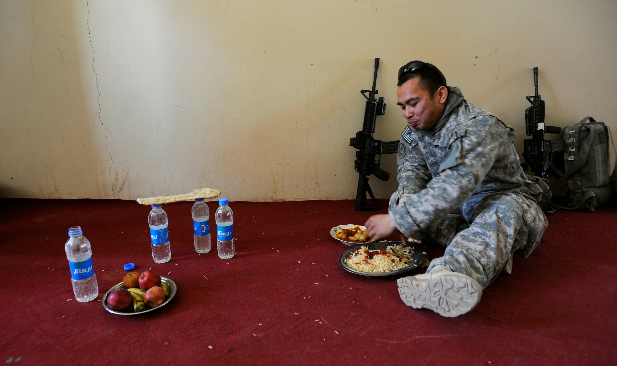 Air Force Staff Sgt. Marc Villano enjoys some of the local cuisine after the opening of the new Shajoy District Center, Dec. 23. Provincial leaders were on hand to open the district center and speak to the more than 90 local villagers in attendance. (U.S. Air Force photo/Staff Sgt. Brian Ferguson) (Released).