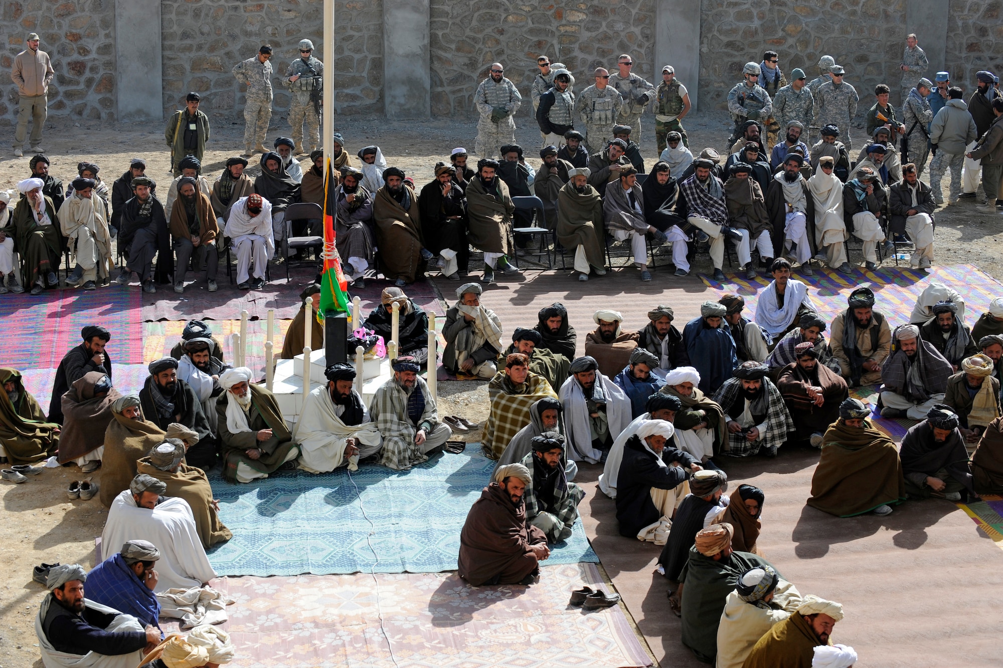 Shajoy District elders listen as Zabul Provincial Gov. Ashraf Naseri speaks during the opening of the Shajoy District Center, Dec. 23. Provincial leaders were on hand to open the district center and speak to the more than 90 local villagers in attendance. (U.S. Air Force photo/Staff Sgt. Brian Ferguson) (Released).