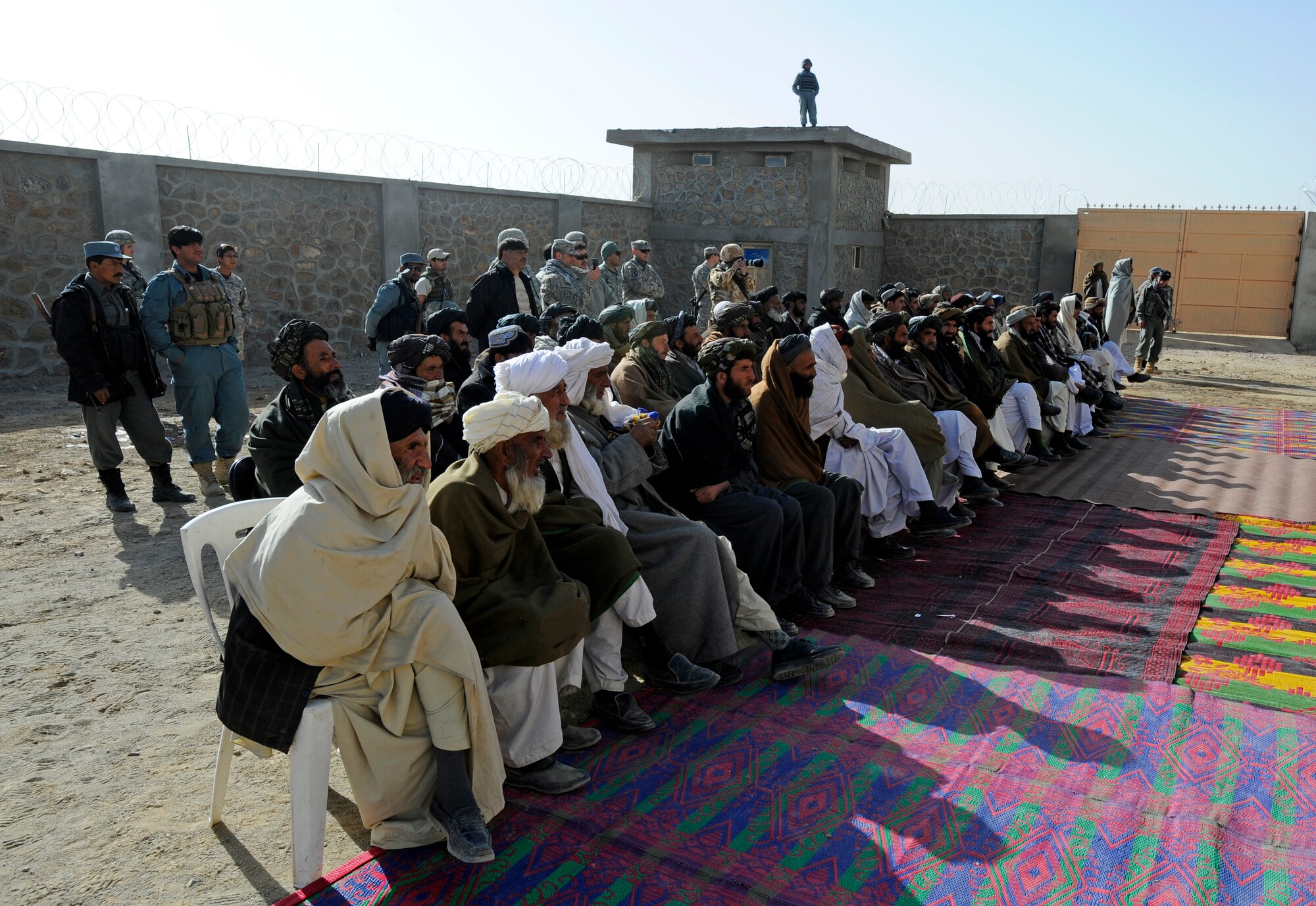 Shajoy District elders listen as Zabul Provincial Gov. Ashraf Naseri speaks during the opening of the Shajoy District Center, Dec. 23. Provincial leaders were on hand to open the district center and speak to the more than 90 local villagers in attendance. (U.S. Air Force photo/Staff Sgt. Brian Ferguson) (Released).