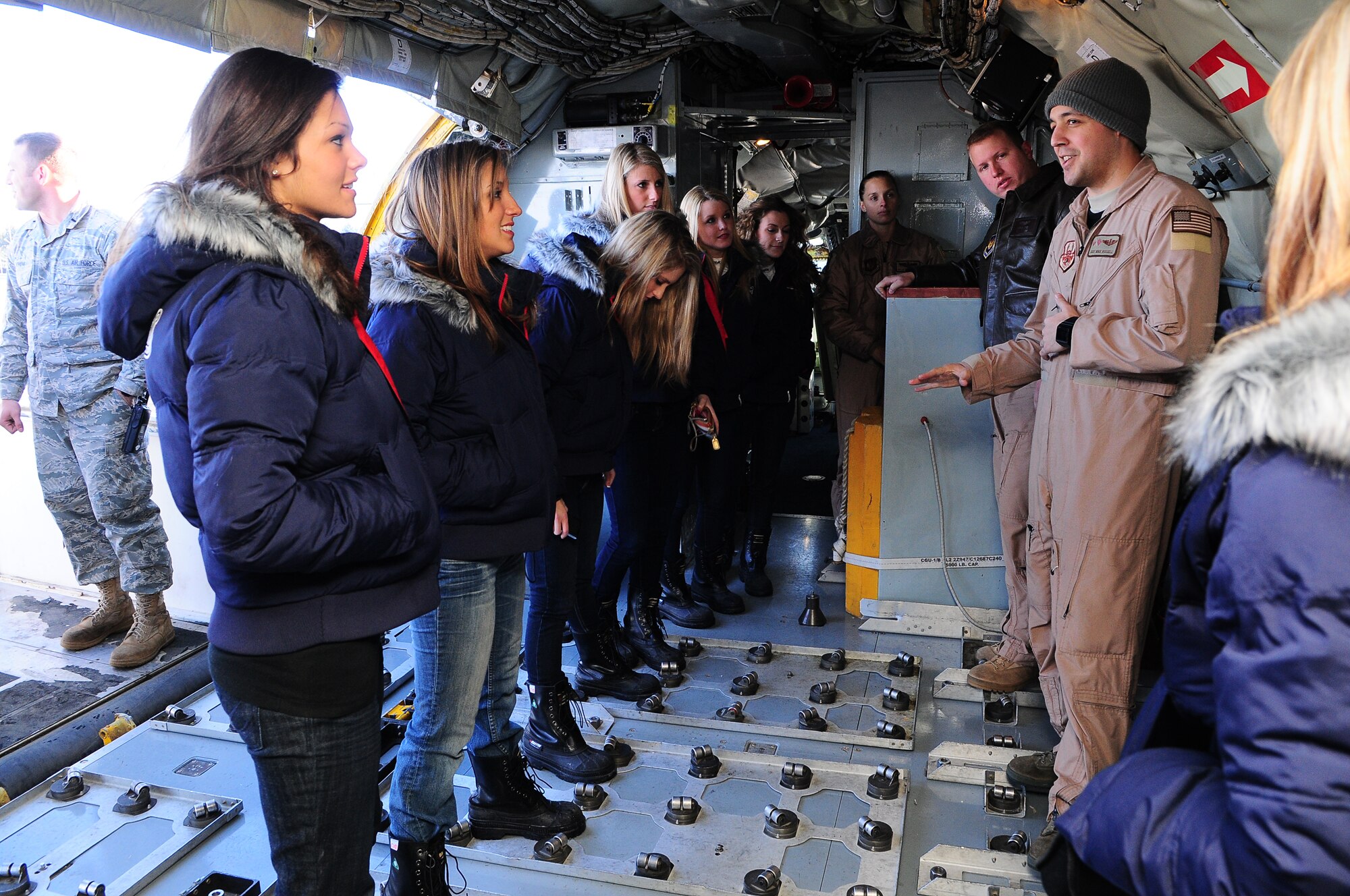 TRANSIT CENTER AT MANAS, Kyrgyzstan - New England Patriot Cheerleaders board a KC-135 Stratotanker during a tour of the Transit Center at Manas as part of an Armed Forces Entertainment tour Dec. 24.  The cheerleaders took a cultural tour of Bishkek, visited a local school and performed for deployed military members. (U.S. Air Force photo/Staff Sgt. Stacy Moless)
