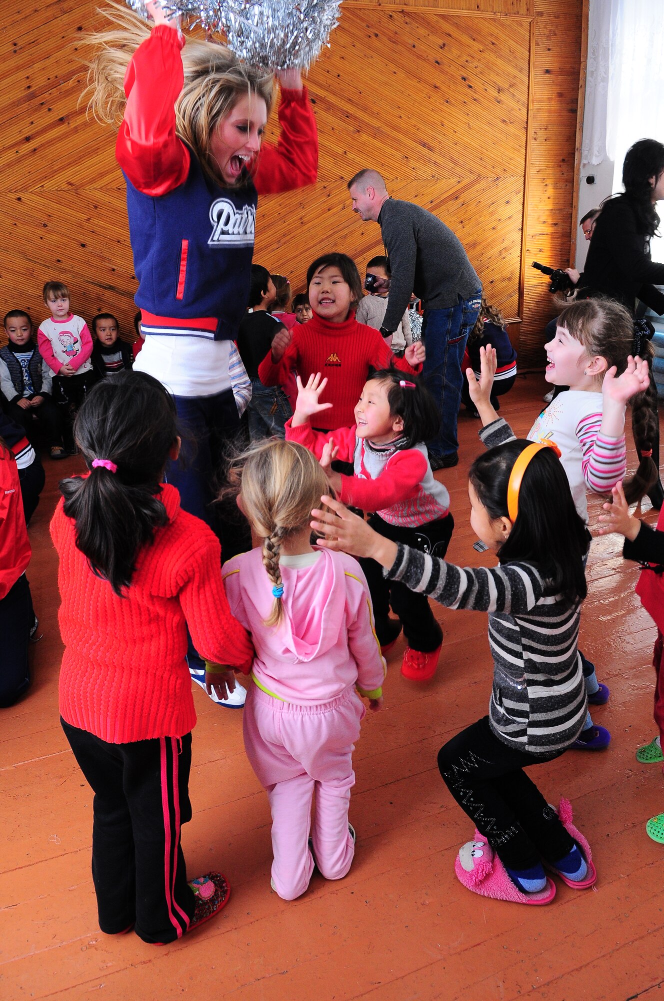 TRANSIT CENTER AT MANAS, Kyrgyzstan - New England Patriot Cheerleaders played with children at a local school as part of an Armed Forces Entertainment tour Dec. 23.  The cheerleaders took a cultural tour of Bishkek, performed for deployed military members and toured the Transit Center at Manas. (U.S. Air Force photo/Staff Sgt. Stacy Moless)