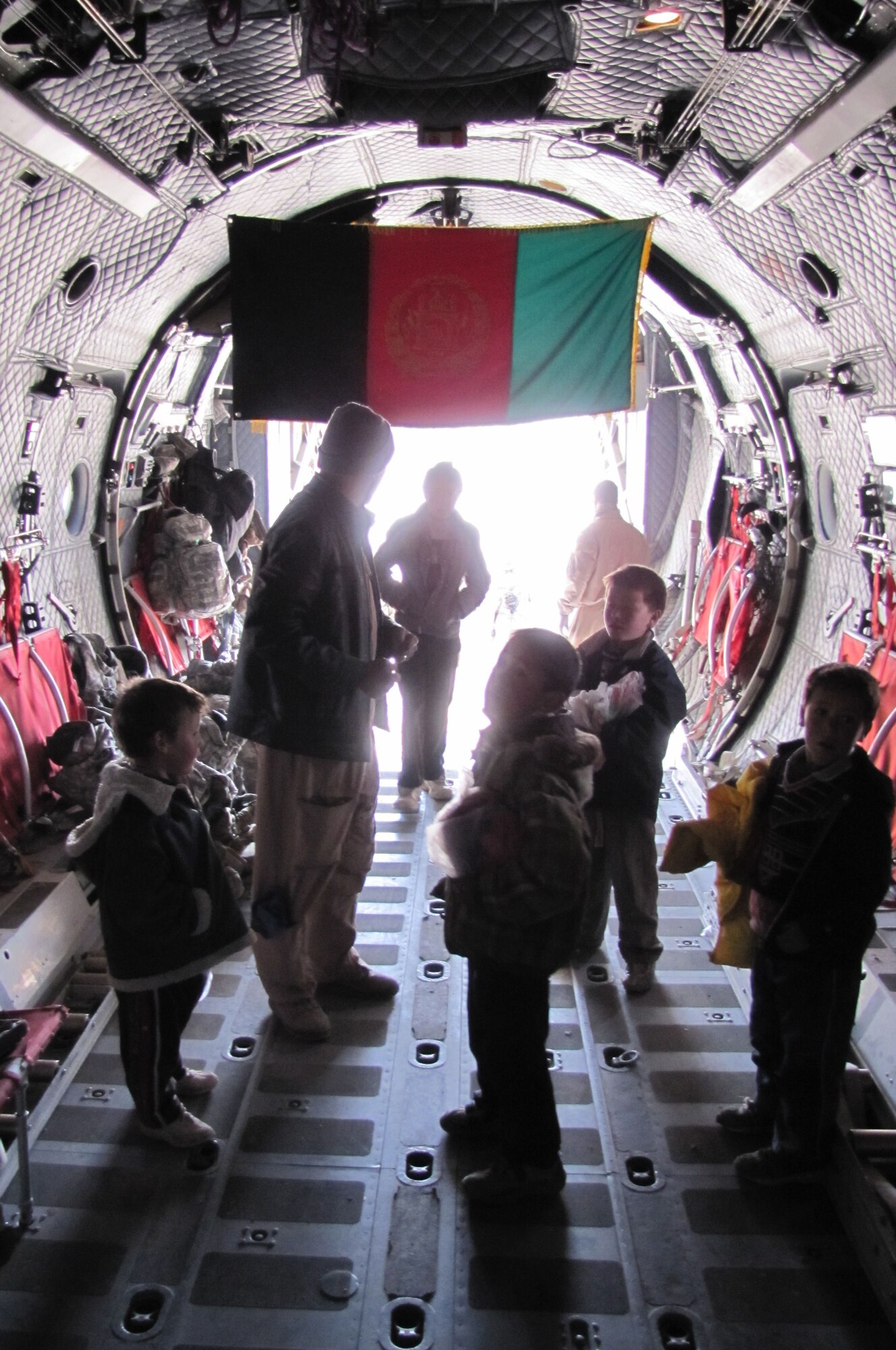 BAMIYAN, Afghanistan -- Afghan Air Force and NATO Air Training Command-Afghanistan troops deliver over 3,600 pounds of supplies as part of a humanitarian assistance mission in Bamiyan province. (U.S. Navy photo by Mass Communications Specialist 3rd Class Jared Walker/RELEASED)