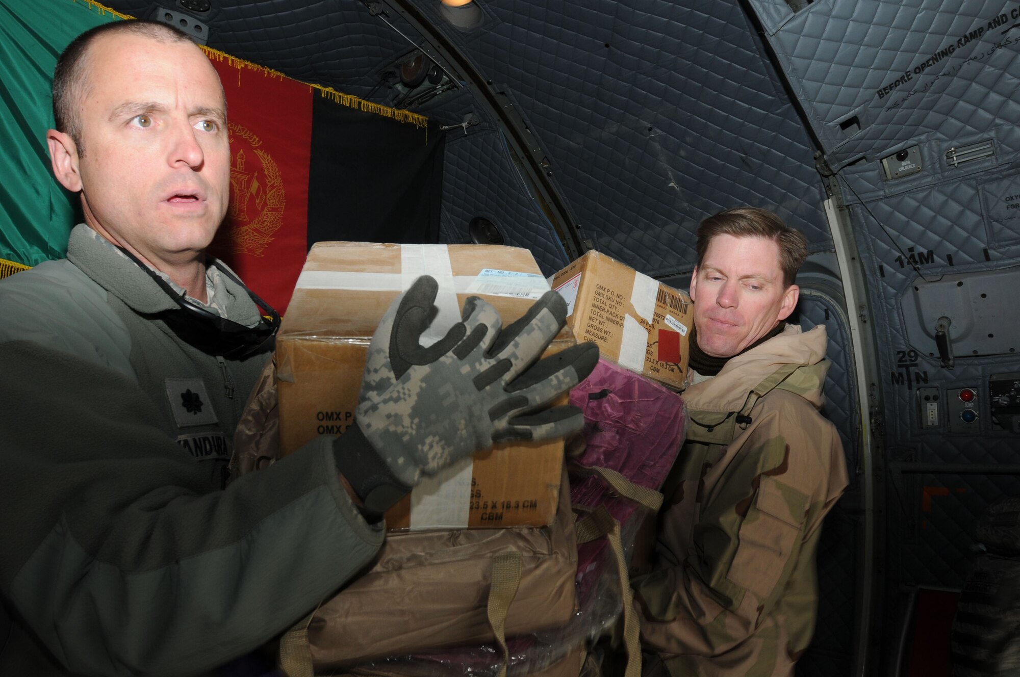 BAMIYAN, Afghanistan -- Afghan Air Force and NATO Air Training Command-Afghanistan troops deliver over 3,600 pounds of supplies as part of a humanitarian assistance mission in Bamiyan province. (U.S. Navy photo by Mass Communications Specialist 2nd Class Vladimir Potapenko/RELEASED)