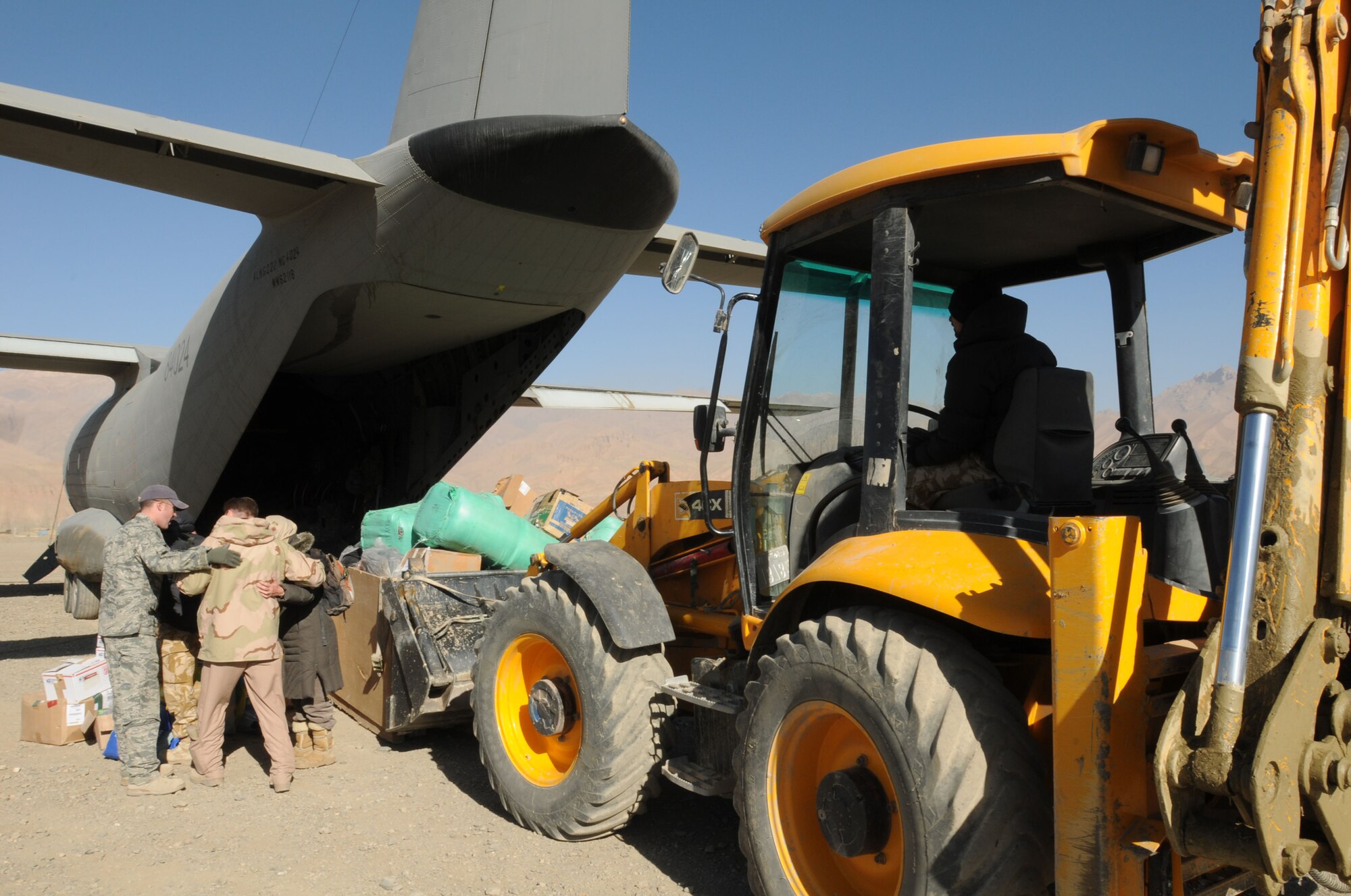 BAMIYAN, Afghanistan -- Afghan Air Force and NATO Air Training Command-Afghanistan troops deliver over 3,600 pounds of supplies as part of a humanitarian assistance mission in Bamiyan province. (U.S. Navy photo by Mass Communications Specialist 2nd Class Vladimir Potapenko/RELEASED)