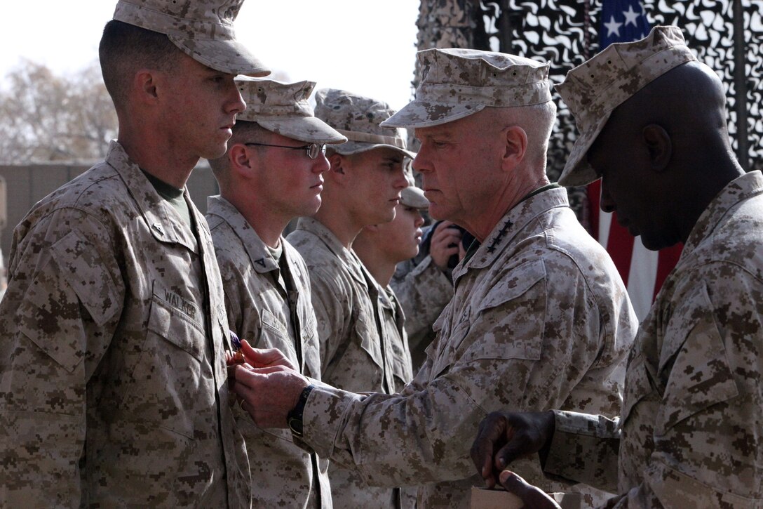 During a Christmas day visit FOB Musa Qal'eh District Center the Commandant, General James Amos, awarded Marines from 1st Battalion, 8th Marine Regiment purple hearts for recent wounds received during combat operations.
