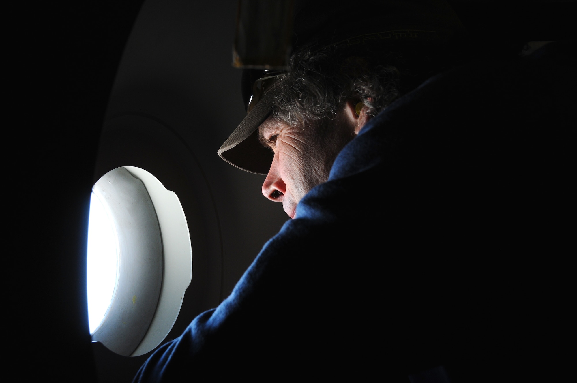 Matt Smith, an Antarctica survival training guide looks out the window of a C-17 Globemaster III Dec. 25, 2010, as it flies over the Ross Sea towards McMurdo Air Station, Antarctica.  The aircraft is assigned to the Air Force Reserve Command’s 728th Airlift Squadron at McChord Air Force Base, Wash.  The C-17 departed Christchurch, New Zealand, but had to turn around as bad weather made it too difficult to land in Antarctica.  (U.S. Air Force photo/Master Sgt. Lee Hoover)