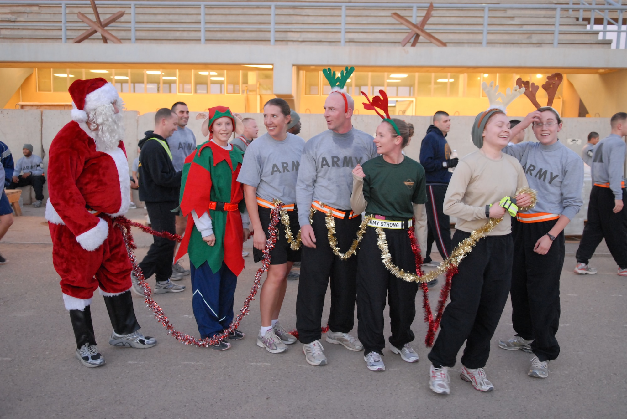 JOINT BASE BALAD, Iraq – Santa’s Soldiers and Airman share a moment after completing the Jingle Bell 5K at Holt Stadium Christmas morning. More than 400 Soldiers, Sailors, Airmen and Marines participated in the Jingle Bell 5K run at Holt Stadium. (U.S. Air Force photo/ Senior Airman Tong Duong)