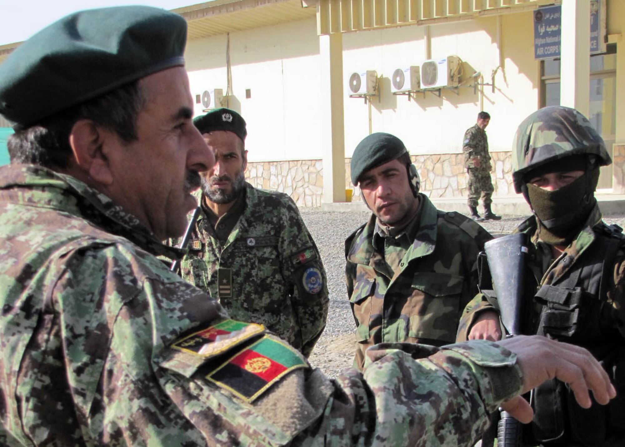 101225-N-6541W-043 KABUL, Afghanistan - Col. Qamarudin, the Afghan Air Force security forces commander, speaks to members of the Afghan Air Force and members of the 438th Air Expeditionary Advisory Squadron Security Forces advisors during an after action report after they conducted an AAF Security Kandak exercise at the Afghan Air Force Base in Kabul, Afghanistan.  (U.S. Navy photo by Mass Communication Specialist 3rd Class Jared Walker/ RELEASED).