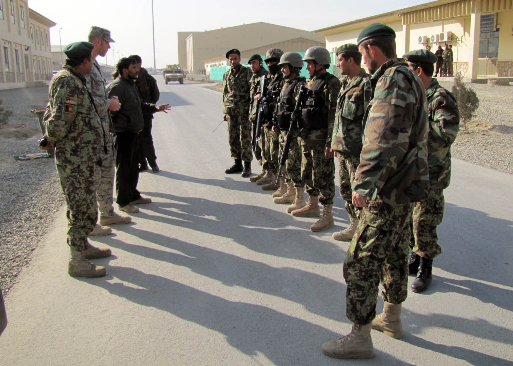 101225-N-6541W-031 KABUL, Afghanistan - Members of the Afghan Air Force and members of the 438th Air Expeditionary Advisory Squadron Security Forces advisors have an after action report after they conducted an AAF Security Kandak exercise at the Afghan Air Force Base in Kabul, Afghanistan.  (U.S. Navy photo by Mass Communication Specialist 3rd Class Jared Walker/ RELEASED).