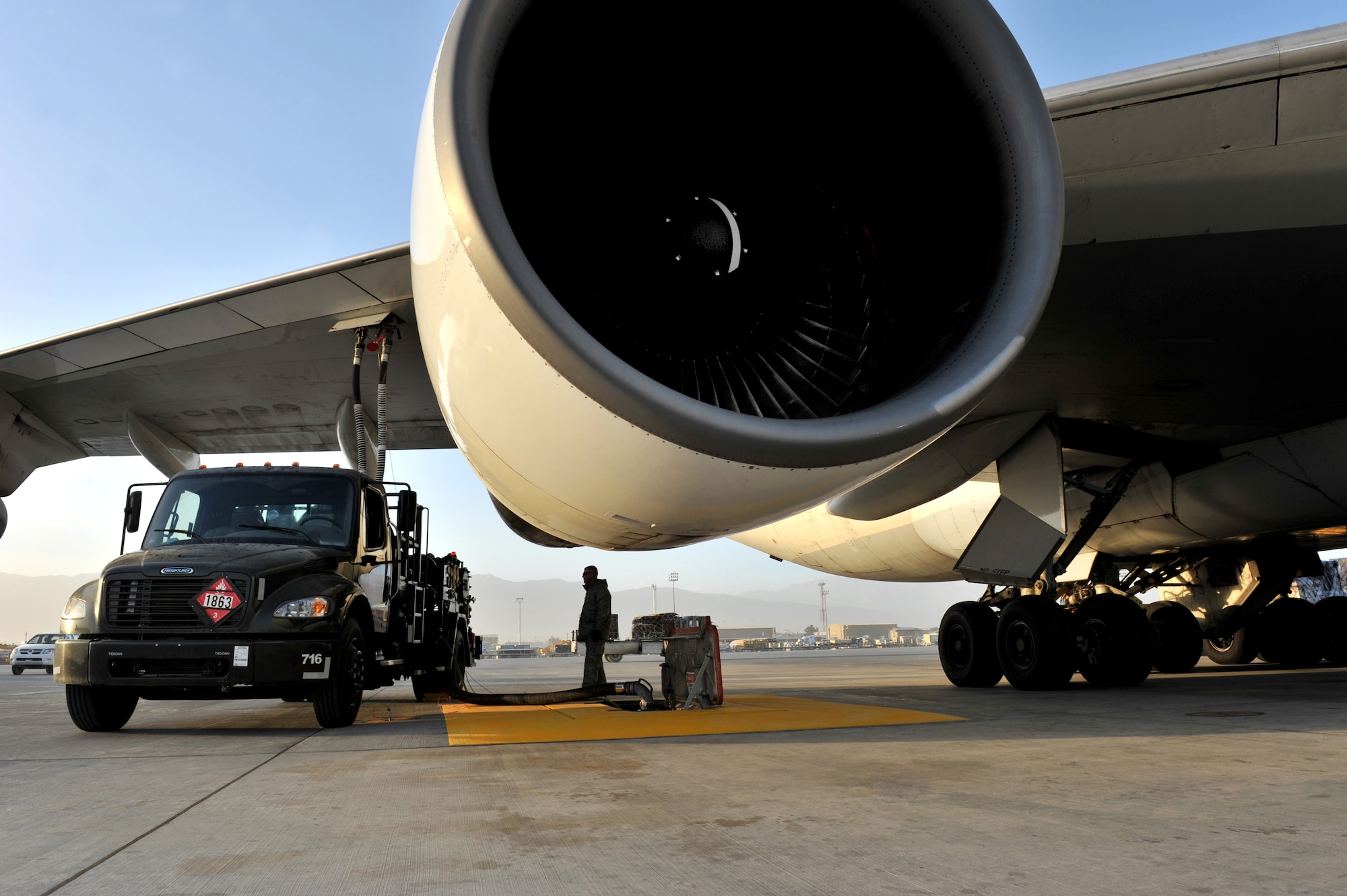 Tech. Sgt. Jeremy Whitworth, 455th Expeditionary Logistics Readiness Squadron section chief of fuels refueling, watches the pressure gauge while refueling an aircraft with the new R-12 hydrant-servicing vehicle at Bagram Airfield, Afghanistan, Dec. 21, 2010. The squadron recently received five HSVs and completed the new Type III constant pressure system became fully operational and will significantly increase refueling capabilities. (DoD photo by U.S. Air Force Senior Airman Sheila deVera/Released)