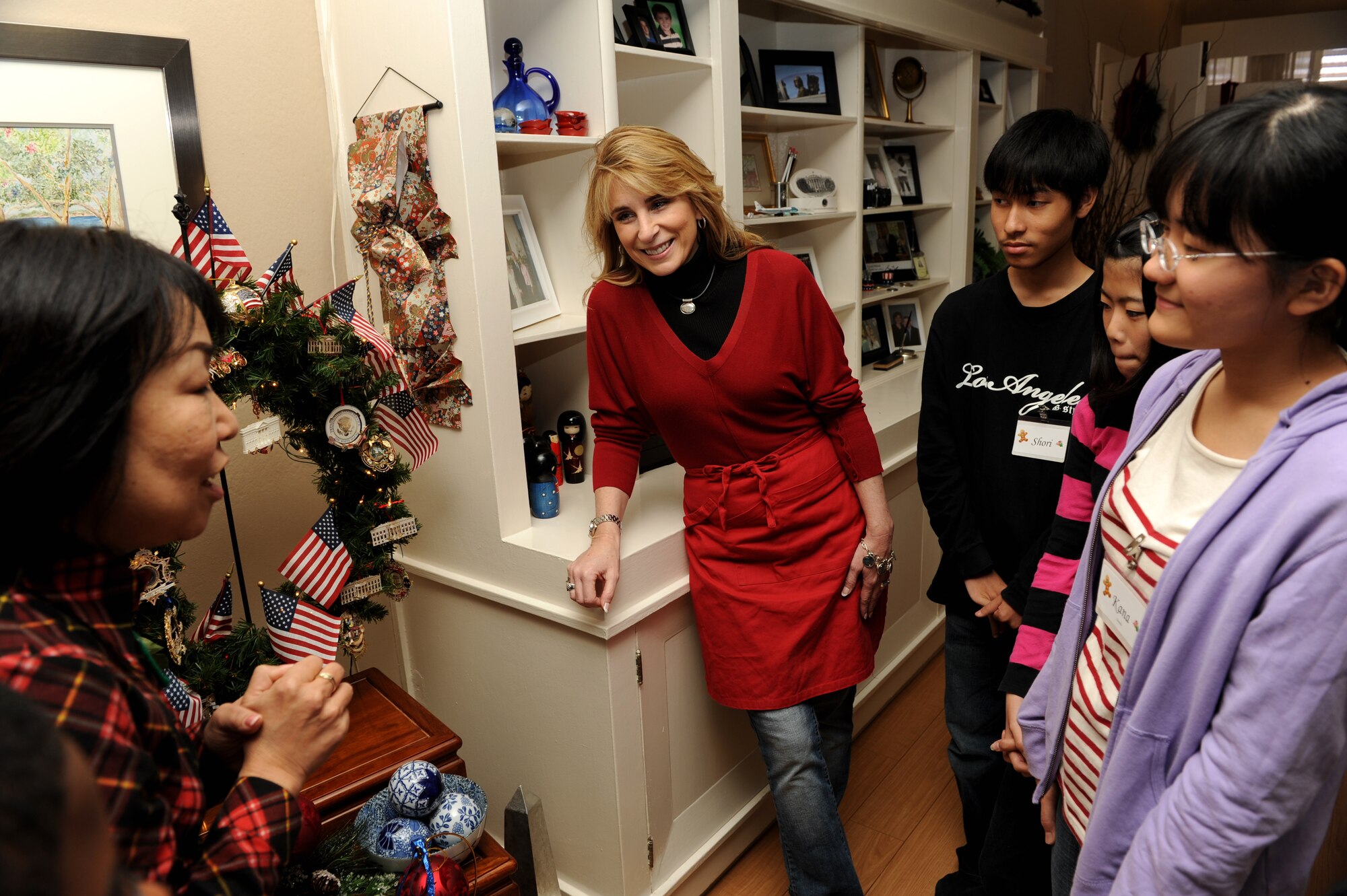 Local students listen to Cindy Wilsbach, wife of Brig. Gen. Ken Wilsbach, 18th Wing commander, as she tells them about working in the White House during a community event at the Wilsbach's home. Japanese junior high and high school students visited Kadena and were treated to a lesson in gingerbread cookie decoration as provided by 18th Wing leadership spouses, Cindy Wilsbach, Charlotte Rupp, wife of Col. Ricky Rupp, 18th Wing vice commander and Pat Davis, wife of Chief Master Sgt. James Davis, 18th Wing command chief master sergeant. (U.S. Air Force Photo/Junko Kinjo)