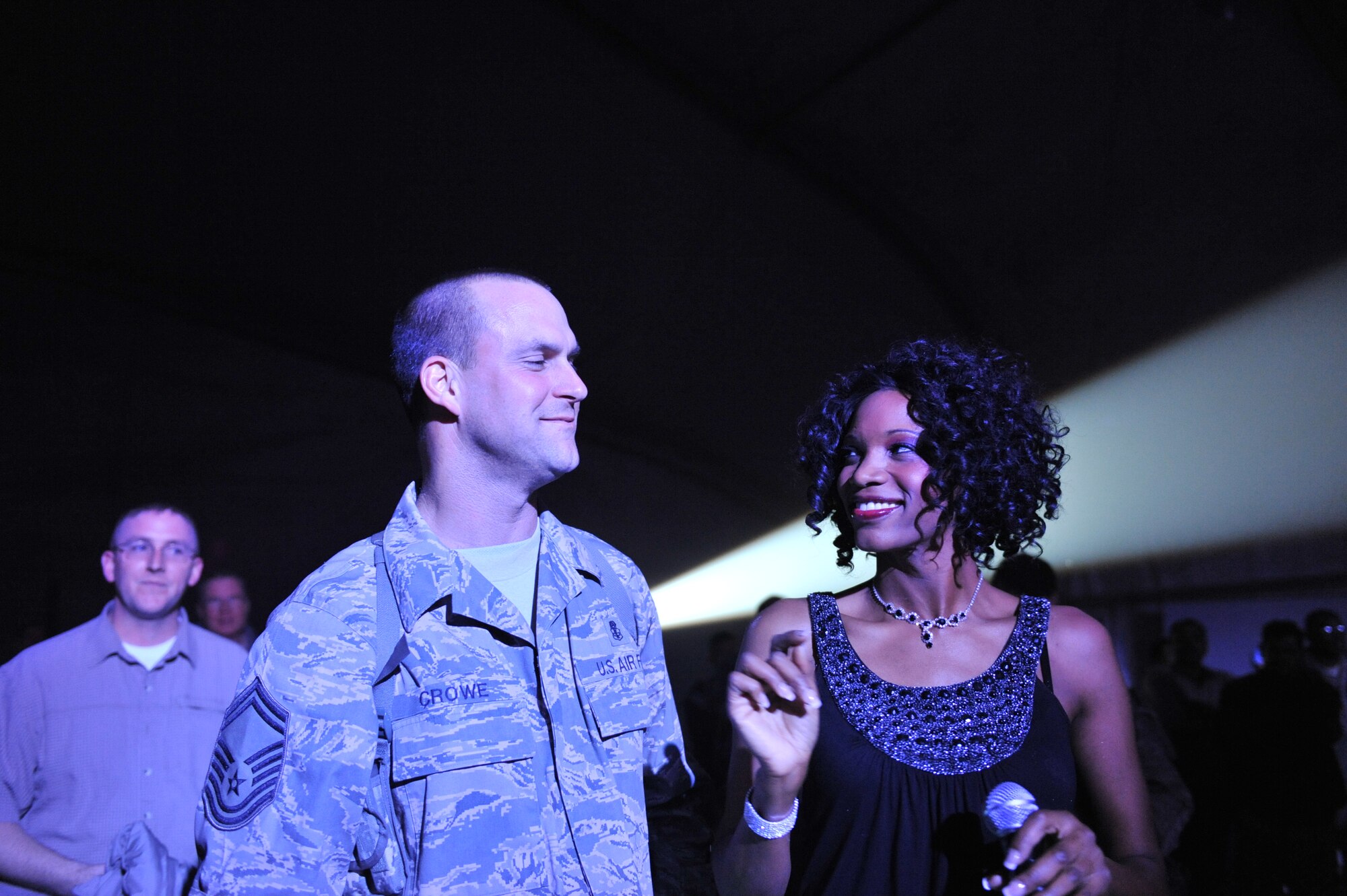 U.S. Air Force Senior Master Sgt. John Crowe, 455th Expeditionary Medical Support Squadron, makes eye contact with Tops in Blue performer, during one of their performances here at Bagram Airfield, Dec. 24, 2010. The Tops in Blue put two shows for the deployed members during the Christmas holiday. (DoD photo by U.S. Air Force Senior Airman Sheila deVera/RELEASED)

