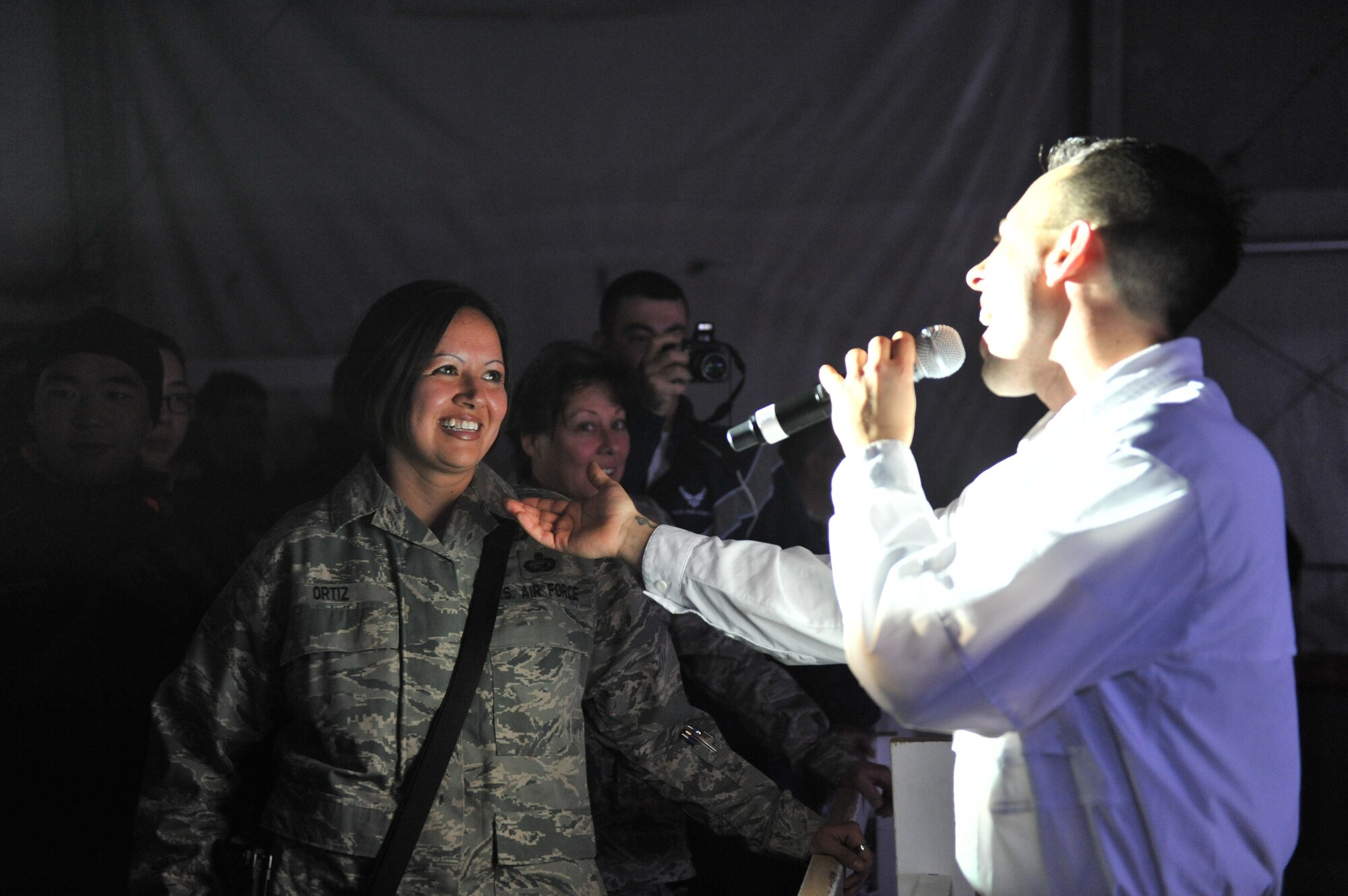 U.S. Air Force Staff Sgt. Steven Sonnier, Tops in Blue vocalist, sing to Master Sgt. Lisa Ortiz, 455th Expeditionary Force Support Squadron, during the Tops in Blue “We Believe” performance at Bagram Airfield, Afghanistan, Dec. 24, 2010. The Tops in Blue put two shows for the deployed members during the Christmas holiday. (DoD photo by U.S. Air Force Senior Airman Sheila deVera/RELEASED)