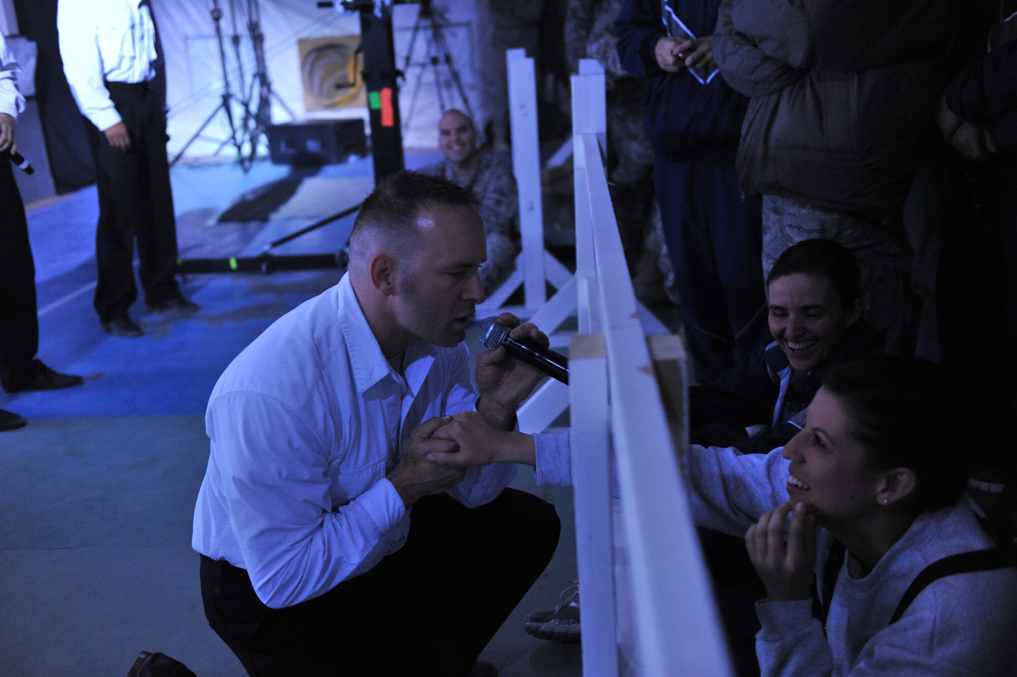 U.S. Air Force Master Sgt. Robert Clark, Tops in Blue vocalist, serenades Staff Sgt. Lindsey Wigden, 455th Expeditionary Logistic Readiness Squadron, Dec. 24, 2010 at Bagram Airfield, Afghanistan.  The Tops in Blue team consists of world-class Air Force active duty talents selected to perform around the world. (DoD photo by U.S. Air Force Senior Airman Sheila deVera/RELEASED)