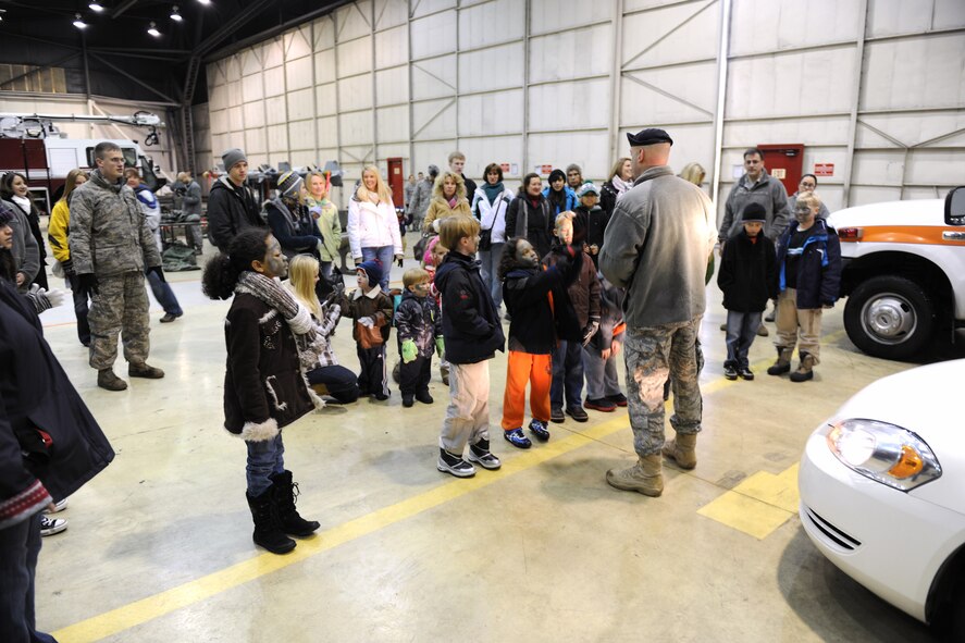 KUNSAN AIR BASE, Republic of Korea -- Lt. Col. Mark Anarumo, 8th Security Forces Squadron commander, briefs children before a military working dog demonstration during a family day here Dec. 27, 2010. The participating families got to see the control tower, get their faces painted, take a tour of Big Coyote and other treats while visiting Kunsan. (U.S. Air Force photo/Senior Airman Ciara Wymbs) 