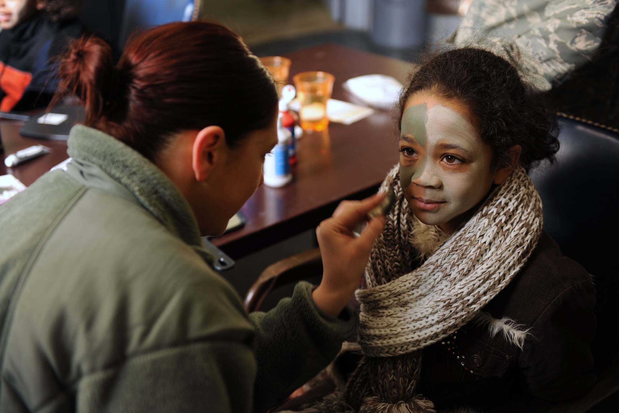 KUNSAN AIR BASE, Republic of Korea -- Staff Sgt. Brittany Sellars, 8th Maintenance Squadron munitions stockpile manager, paints Nakia Jackon's face during a family day here Dec. 27, 2010. Face painting, a military working dog demonstration and other events were offered to families visiting Kunsan during the holidays. Nakia is the daughter of Tech Sgt. Herman Jackson, 8th Force Support Squadron. (U.S. Air Force photo/Senior Airman Ciara Wymbs) 