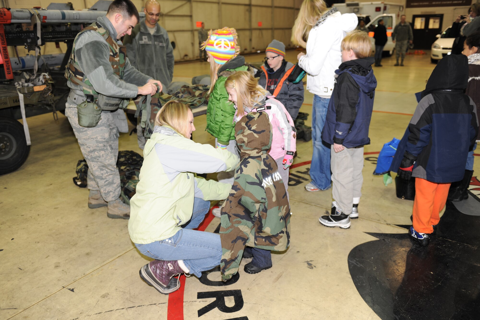 KUNSAN AIR BASE, Republic of Korea -- Families participating in family day try on chemical protection gear here Dec. 27, 2010. During family day participants got a military working dog demonstration, face painting, tour of the base and other activities. (U.S. Air Force photo/Senior Airman Ciara Wymbs) 