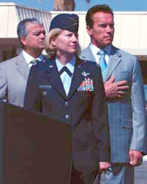 Alongside Governor Arnold Schwarzenegger, 452nd Air Mobility Wing vice commander, Col. Mary Aldrian, watches the Blue Eagles Total Force Honor Guard preparing to post the colors.  (U.S. Air Force photo by Staff Sgt. Megan Crusher)
