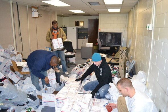 KUNSAN AIR BASE, Republic of Korea -- Kunsan volunteers unpack more than 3,000 handmade stockings from more than 700 boxes sent to Capt. Jeff Fowlkes, 8th Civil Engineer Squadron, for distribution to the Wolf Pack on Dec. 25. The stockings were sewn, filled and sent by volunteers from the Westminster Presbyterian Church in Lubbock, Texas. (Courtesy photo)