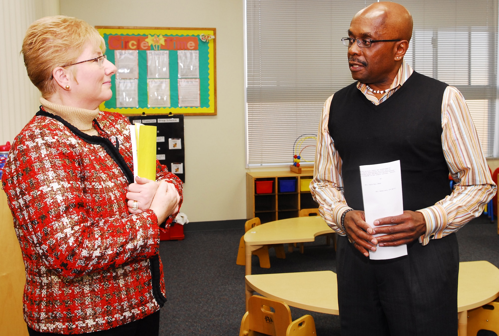 YOKOTA AIR BASE, Japan -- Mrs. Paula Roy, spouse of the Chief Master Sergeant of the Air Force, listens as Phil Murrey, a social worker for Educational and Developmental Intervention Services, talks about their mission to help children with special needs achieve their developmental and educational potential. Mrs. Roy accompanied her husband to Yokota Dec. 27 to discuss the Child Development Operation, Noncombatant Evacuation Operations, Military Family Member Life Consultant Programs and Key Spouses Program. (U.S. Air Force photo/Airman 1st Class Lynsie Nichols)