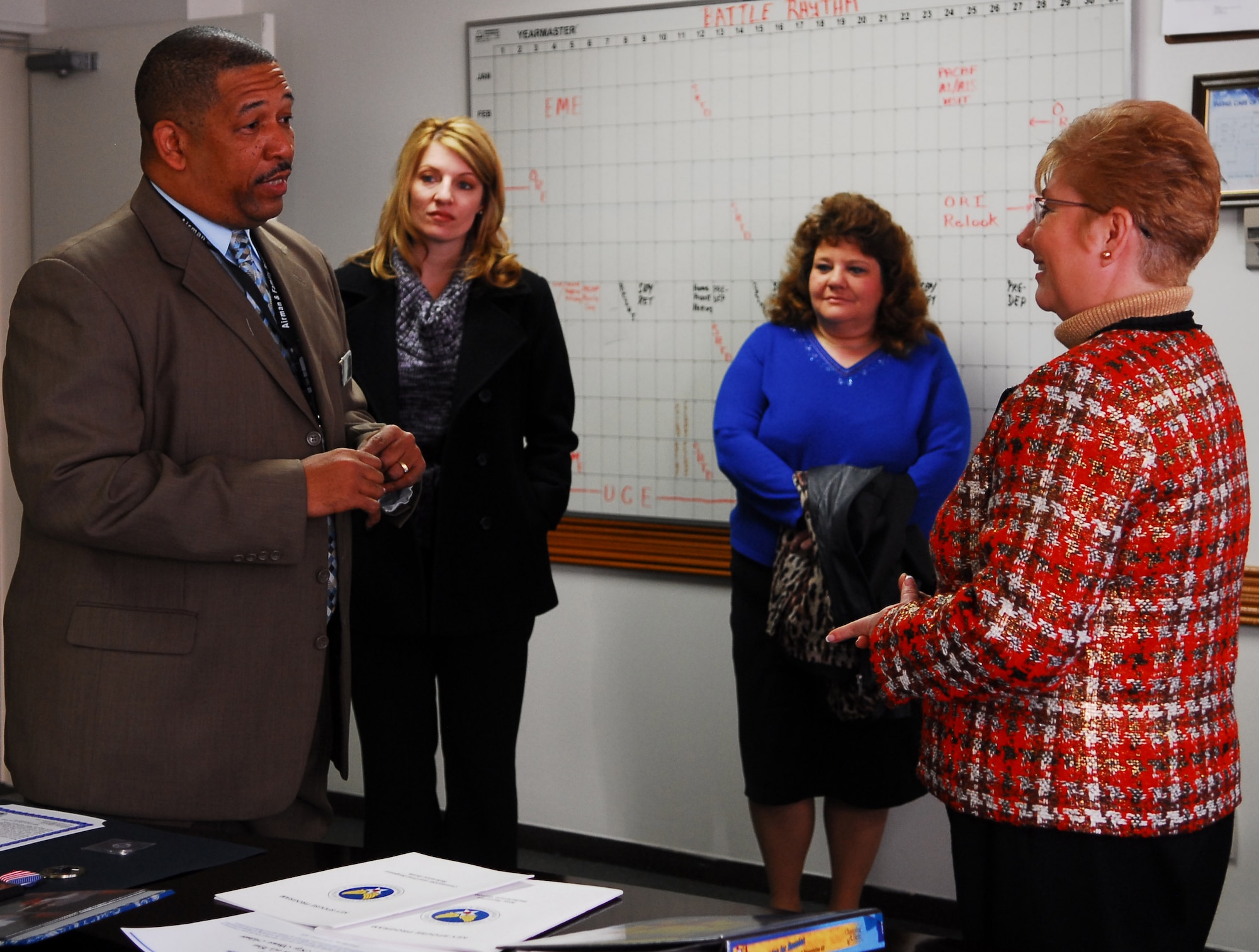 YOKOTA AIR BASE, Japan -- Steven Mayfield, chief of Airman and Family Readiness, discusses Yokota's evacuation plan with Mrs. Paula Roy, spouse of the Chief Master Sergeant of the Air Force, Mrs. Denna Caro, spouse of the 374th Airlift Wing Command Chief and Mrs. Debbie Kaiser, spouse of the 5th Air Force Command Chief. Mrs. Roy accompanied her husband to Yokota Dec. 27 to discuss the Child Development Operation, Noncombatant Evacuation Operations, Military Family Member Life Consultant Programs and Key Spouses Program. (U.S. Air Force photo/Airman 1st Class Lynsie Nichols)