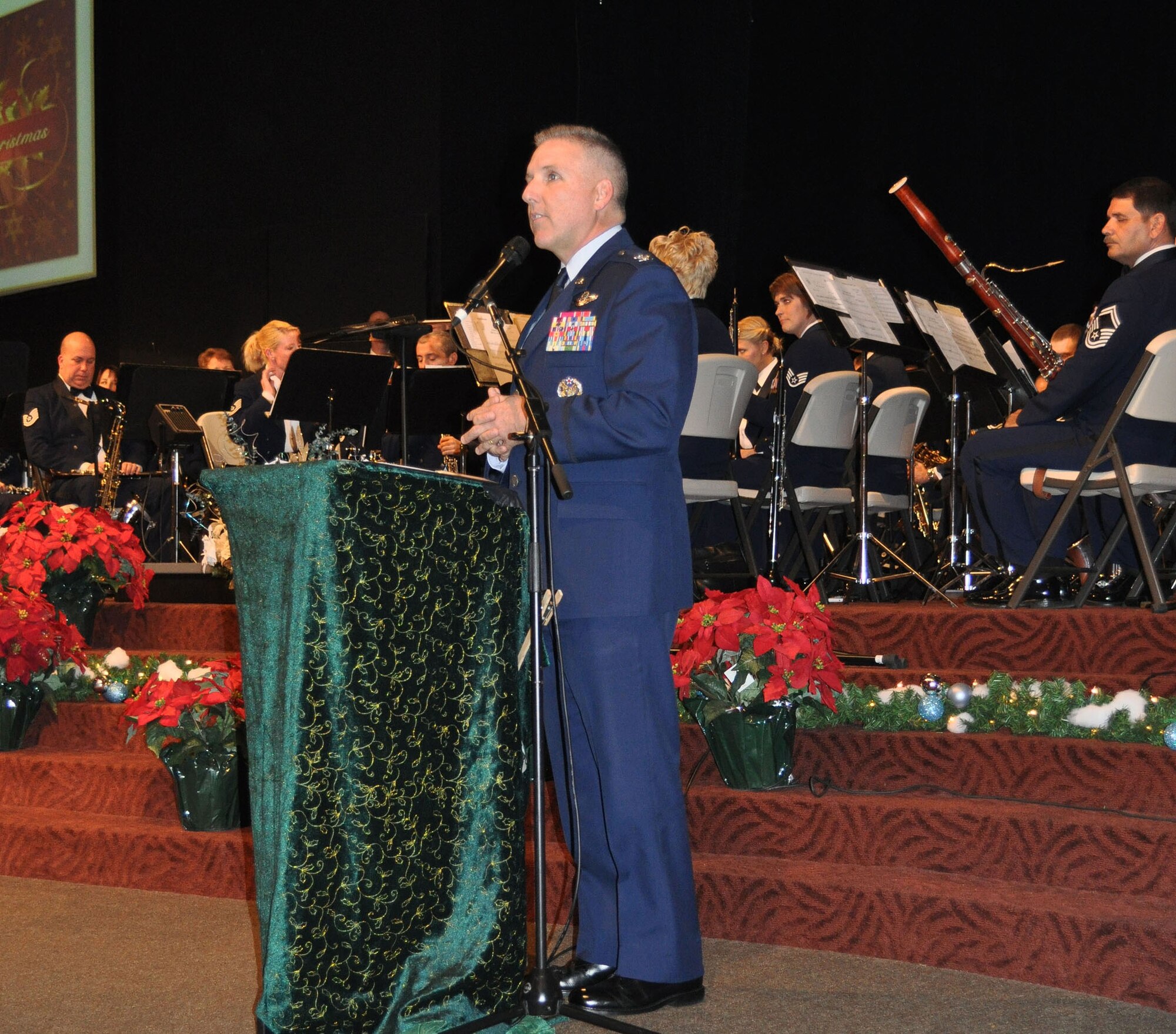 TRAVIS AIR FORCE BASE, Calif. -- Col. Jay Flournoy, commander, 349th Air Mobility Wing here, got in the spirit of the holidays with the 60th AMW Band of the Golden West Dec. 7, 2010. The Colonel welcomed people from local communities to the free concert at the Liberty Christian Center in Fairfield. This concert was one of many performed by the Travis Band, as they go out in the communities as the Air Force Ambassadors of Music. (U.S. Air Force photo/Senior Master Sgt. Ellen L. Hatfield)