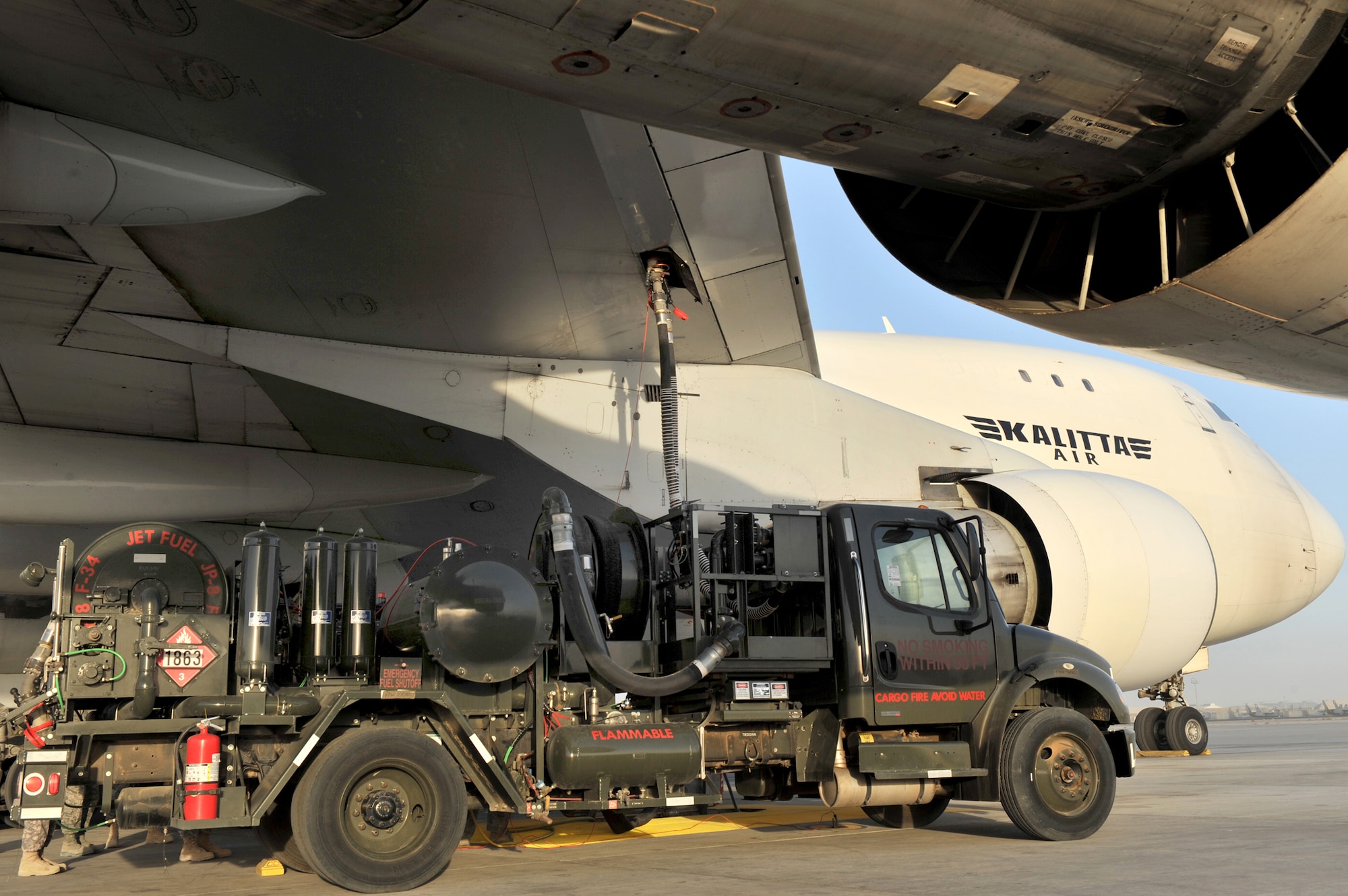 Tech. Sgt. Jeremy Whitworth supervises a cargo aircraft refueling with the new R-12 hydrant servicing vehicle Dec. 21, 2010, at Bagram Airfield, Afghanistan. Sergeant Whitworth is the 455th Expeditionary Logistics Readiness Squadron chief of refueling. (DOD photo/Senior Airman Sheila deVera)