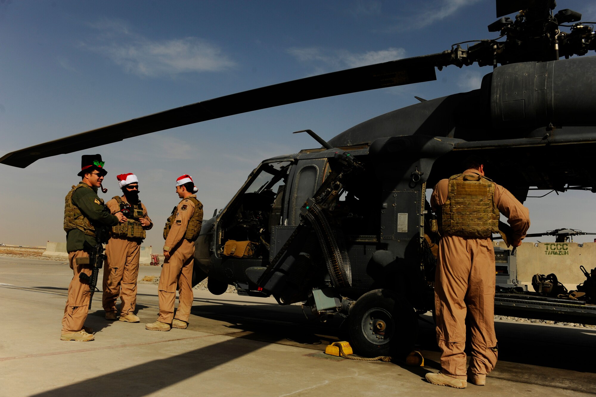 A U.S. Air Force aircrew from the 26th Expeditionary Rescue Squadron conduct pre-flight checks on an HH-60 Pave Hawk in order to be ready for a mission at a moment's notice at Kandahar Airfield, Afghanistan, Dec. 25, 2010. The rescue squadrons are on alert 24/7 including holidays like Christmas. (U.S. Air Force photo by SSgt. Eric Harris, U.S. Air Forces Central Public Affairs / Released)