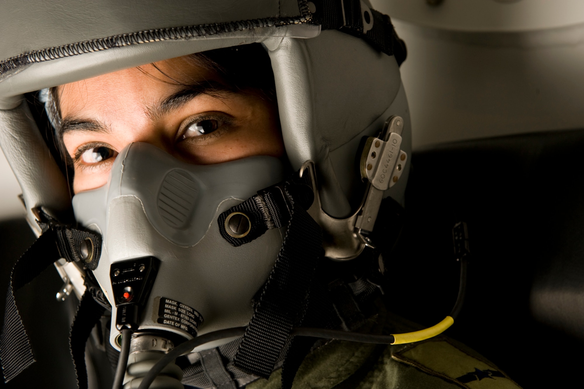 Donning an aviator oxygen mask, Colombian, Maj. Alexandra Mejia, an aerospace medicine specialist, 
is ready for a hypobaric chamber flight.(Photo by TSgt Samuel Bendet)